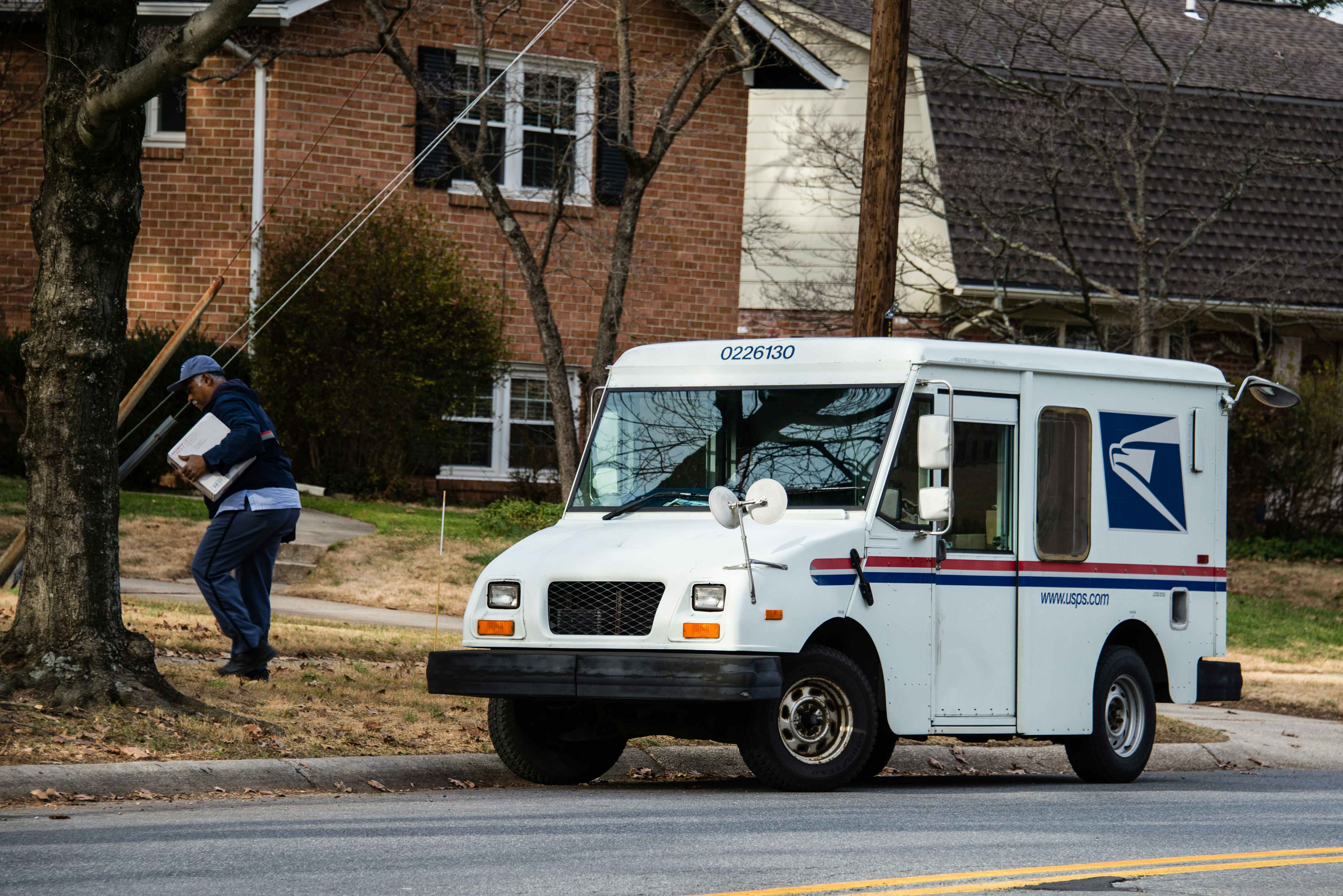 USPS mail truck pulled up to the curb