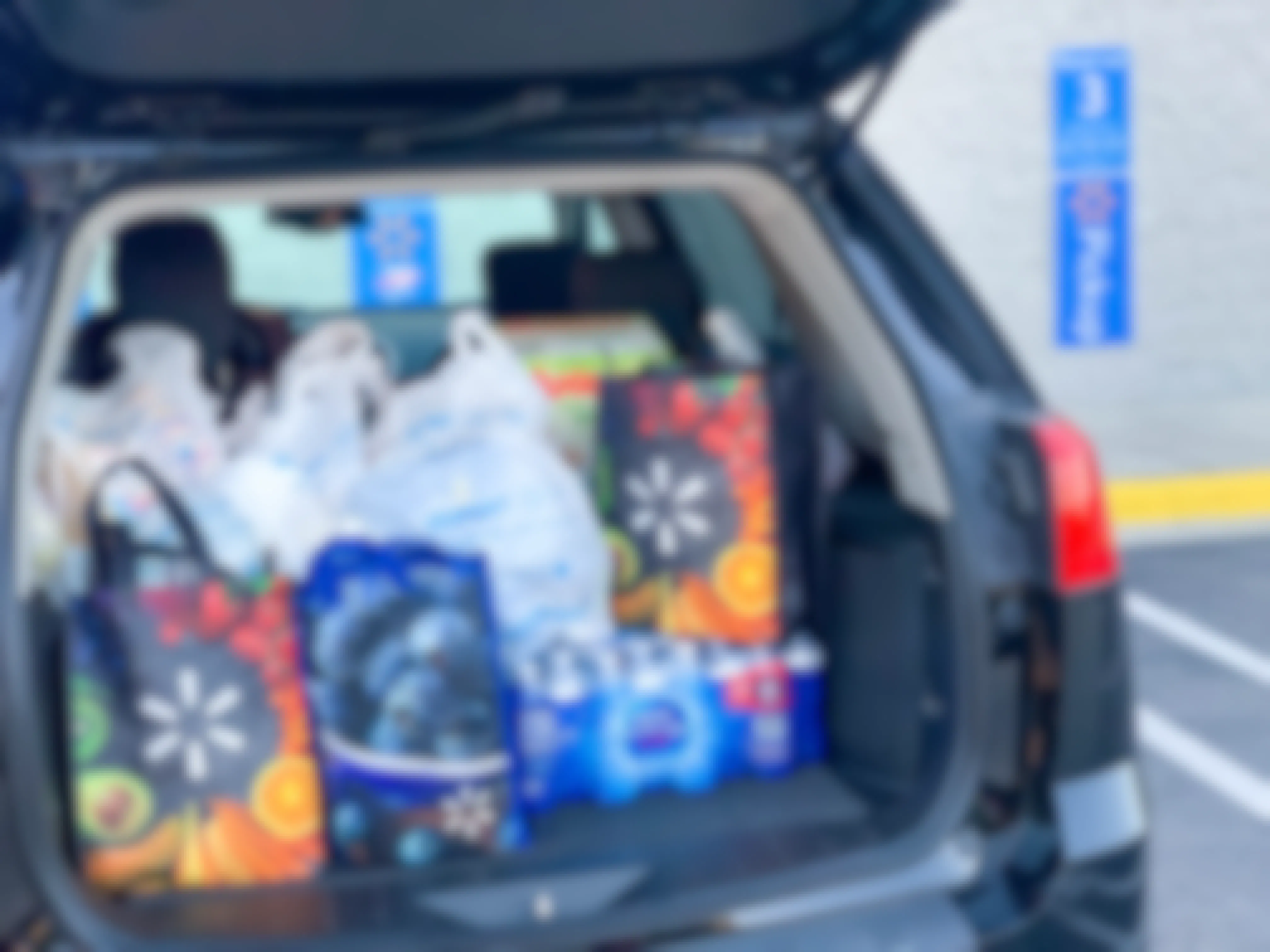 The trunk of a car loaded with Walmart bags during a Walmart curbside pickup