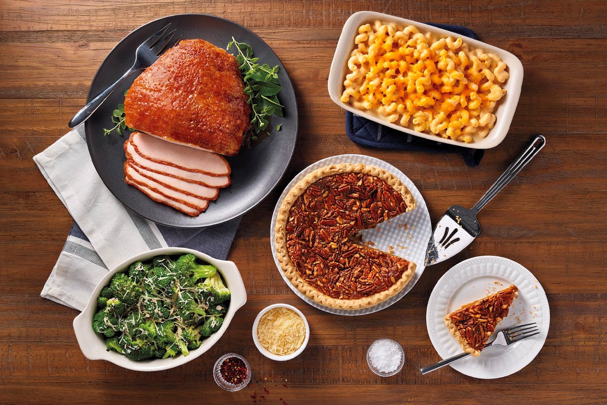 An Easter dinner from Honey Baked Ham Company on a wood table