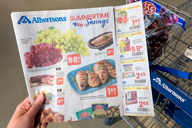 An Albertsons ad with coupons held inside a store.