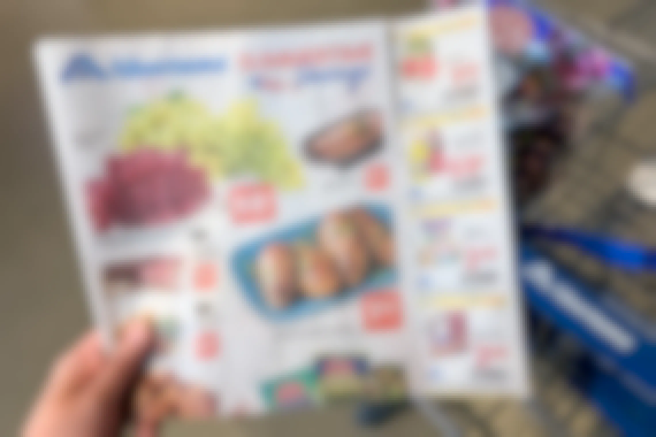 An Albertsons ad with coupons held inside a store.
