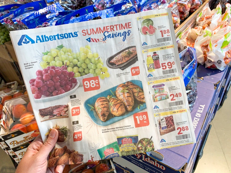 An Albertsons ad with coupons held inside a store.