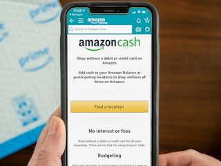 A person's hands holding up a cell phone displaying the Amazon Cash page on the Amazon mobile app.