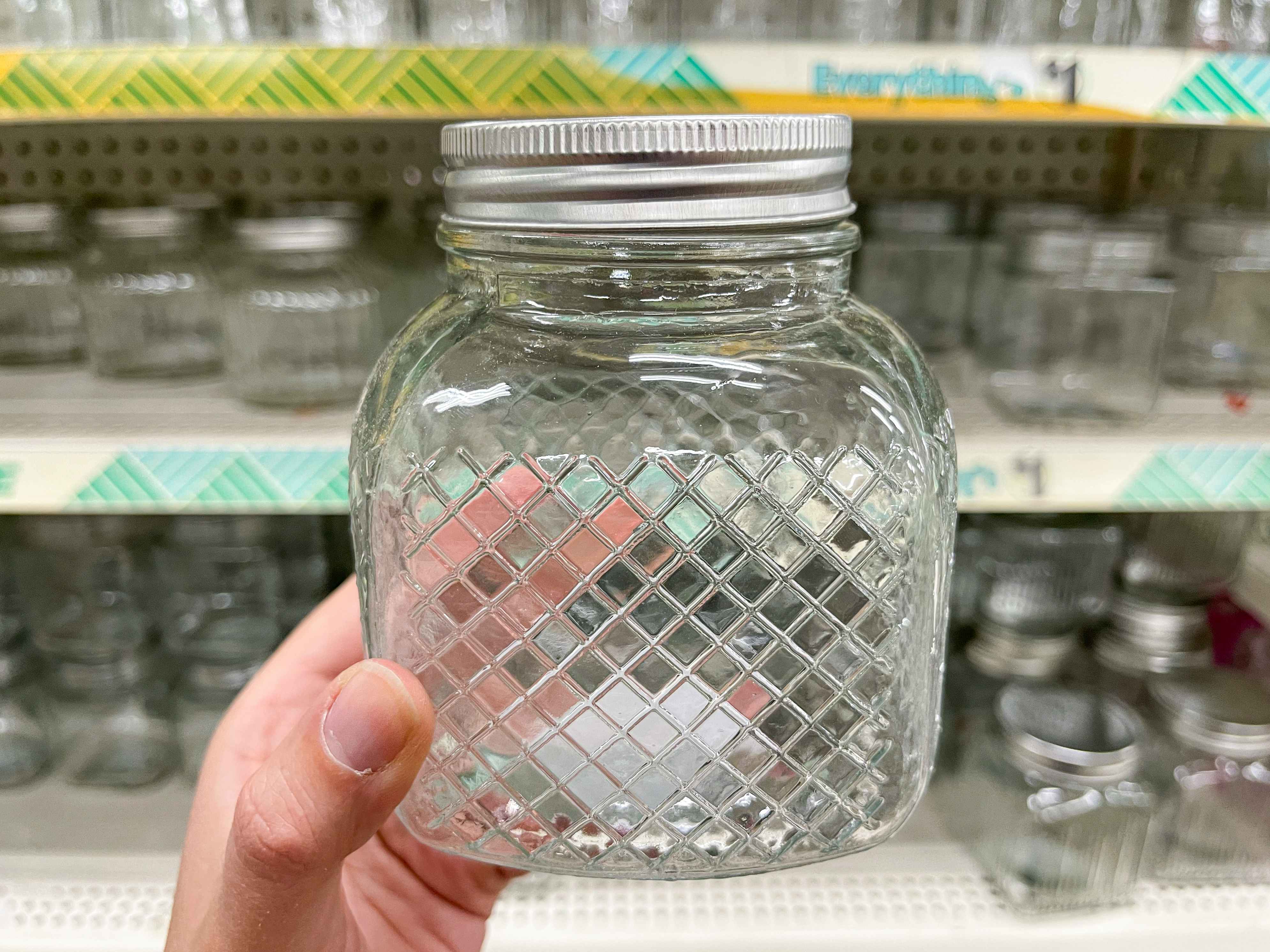 holding glass jar with lid in dollar tree aisle