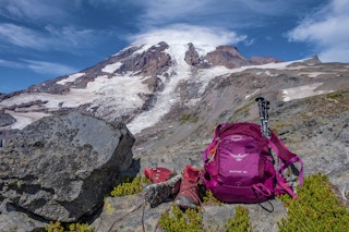osprey backpack on a rock with mountain behind it