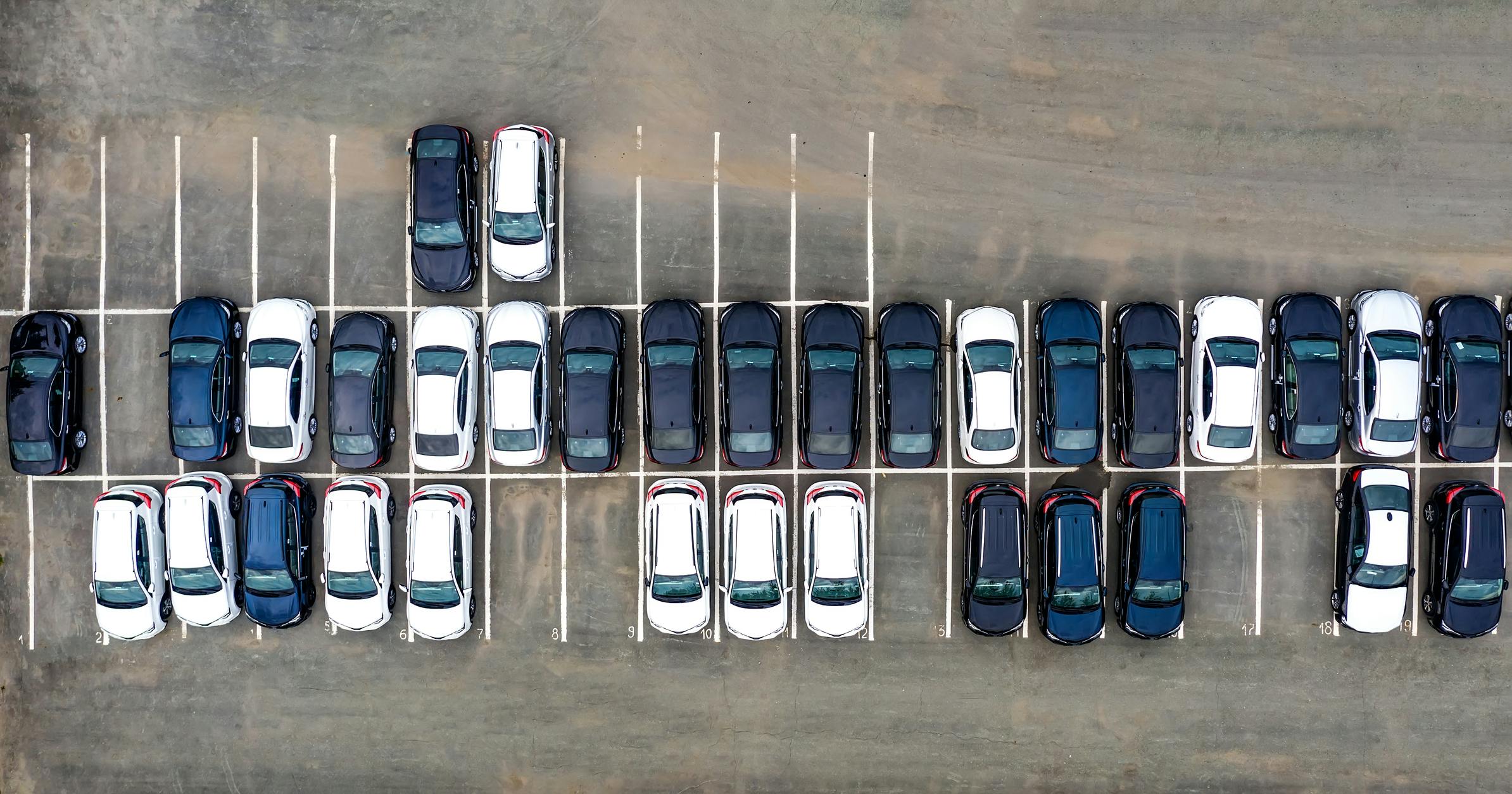 An aerial view of a car lot with several parked cars.
