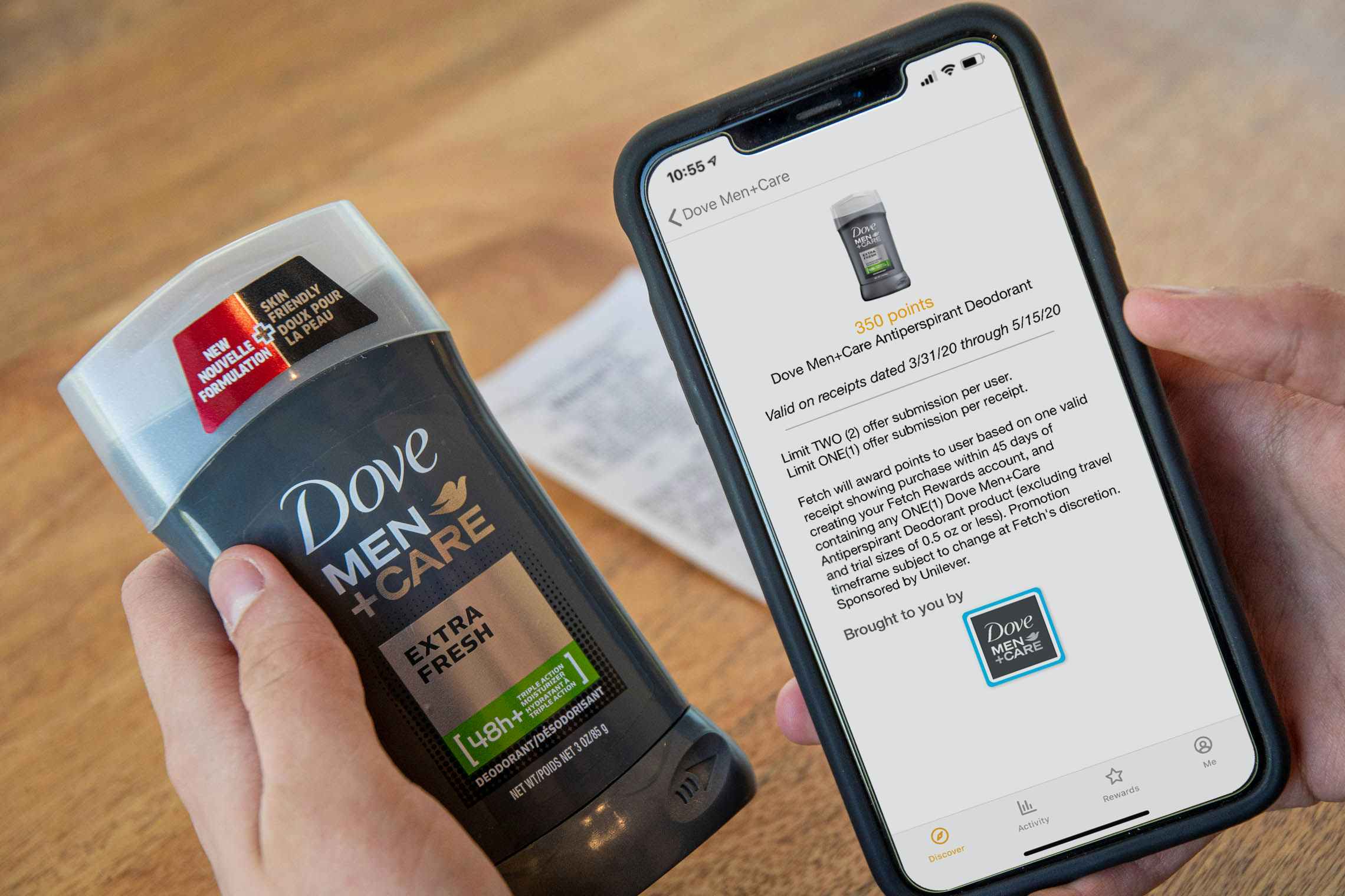 A person holding a stick of Dove men+care deodorant next to a phone displaying a deal for that product in the Fetch Rewards app.