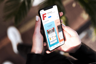 hand holds iphone with app store open and fred meyer app for download