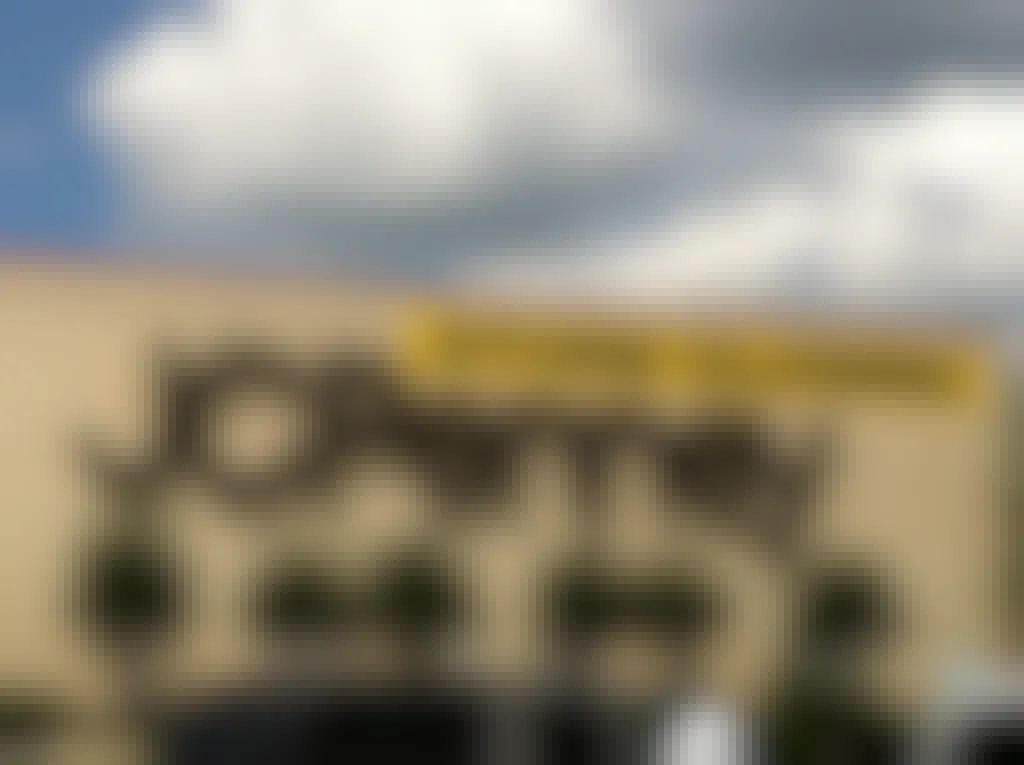 close up of JCPenny store sign on the side of the building with a yellow banner above reading "store closing".