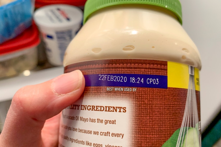 Person pointing to the expiration date on newly expired mayo.