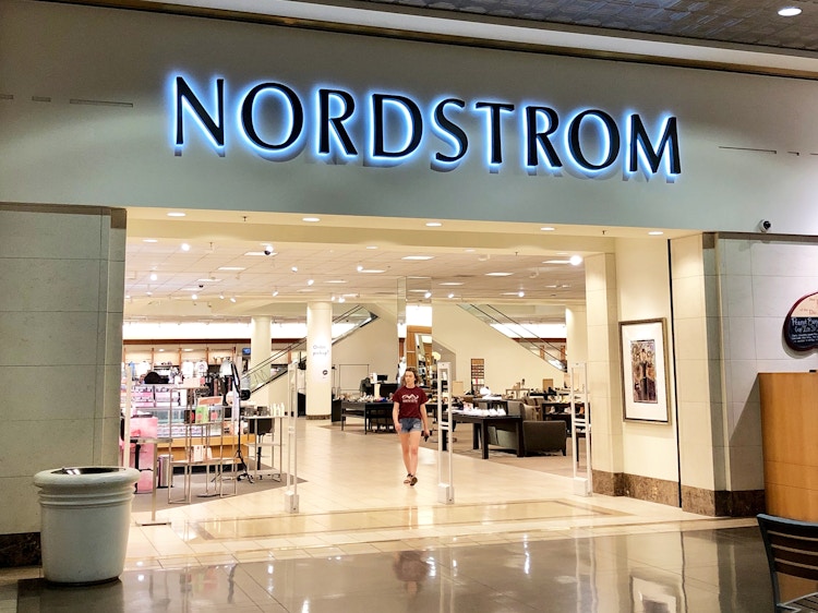 a person walking out of a nordstom store