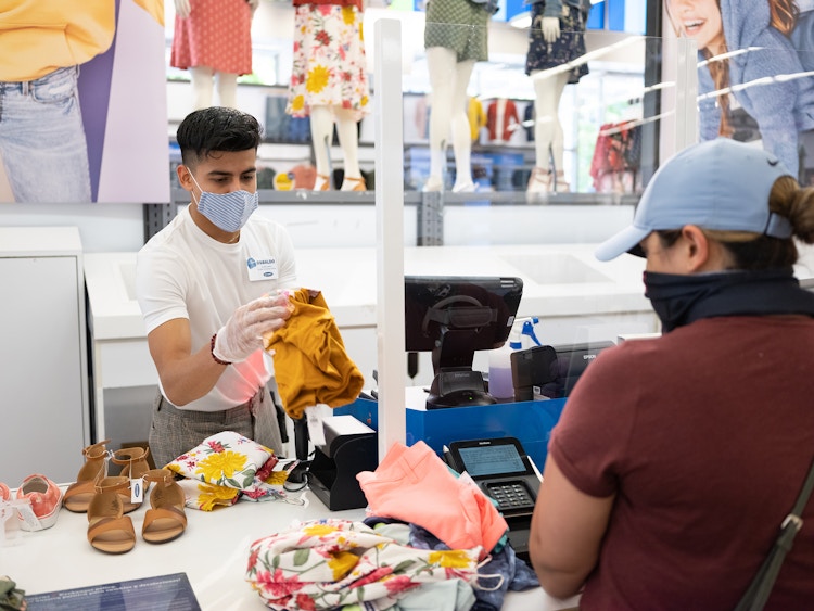old navy worker in a mask sells to customer in a mask