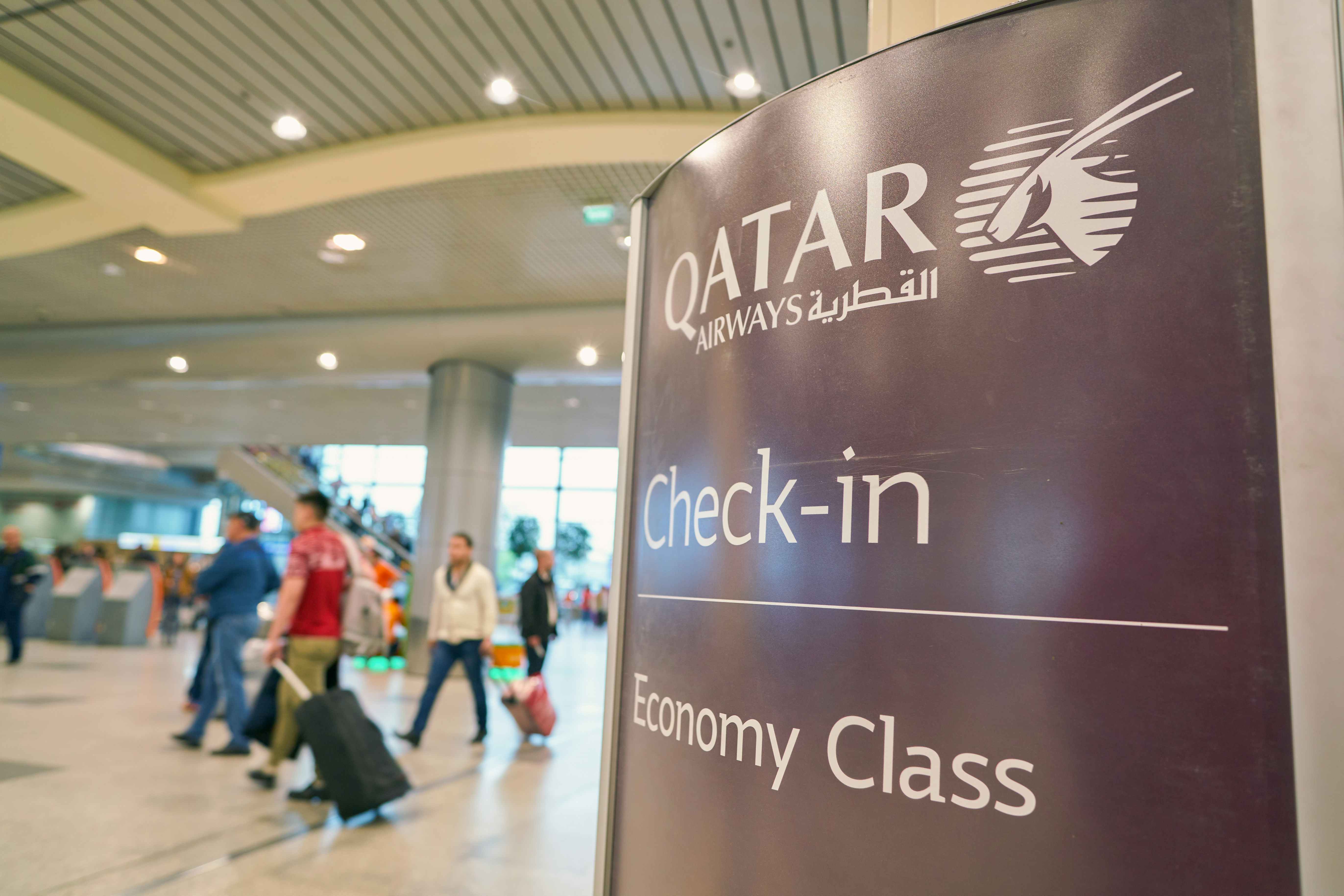 Qatar Airways Check-In sign for Economy Class passengers in the airport.