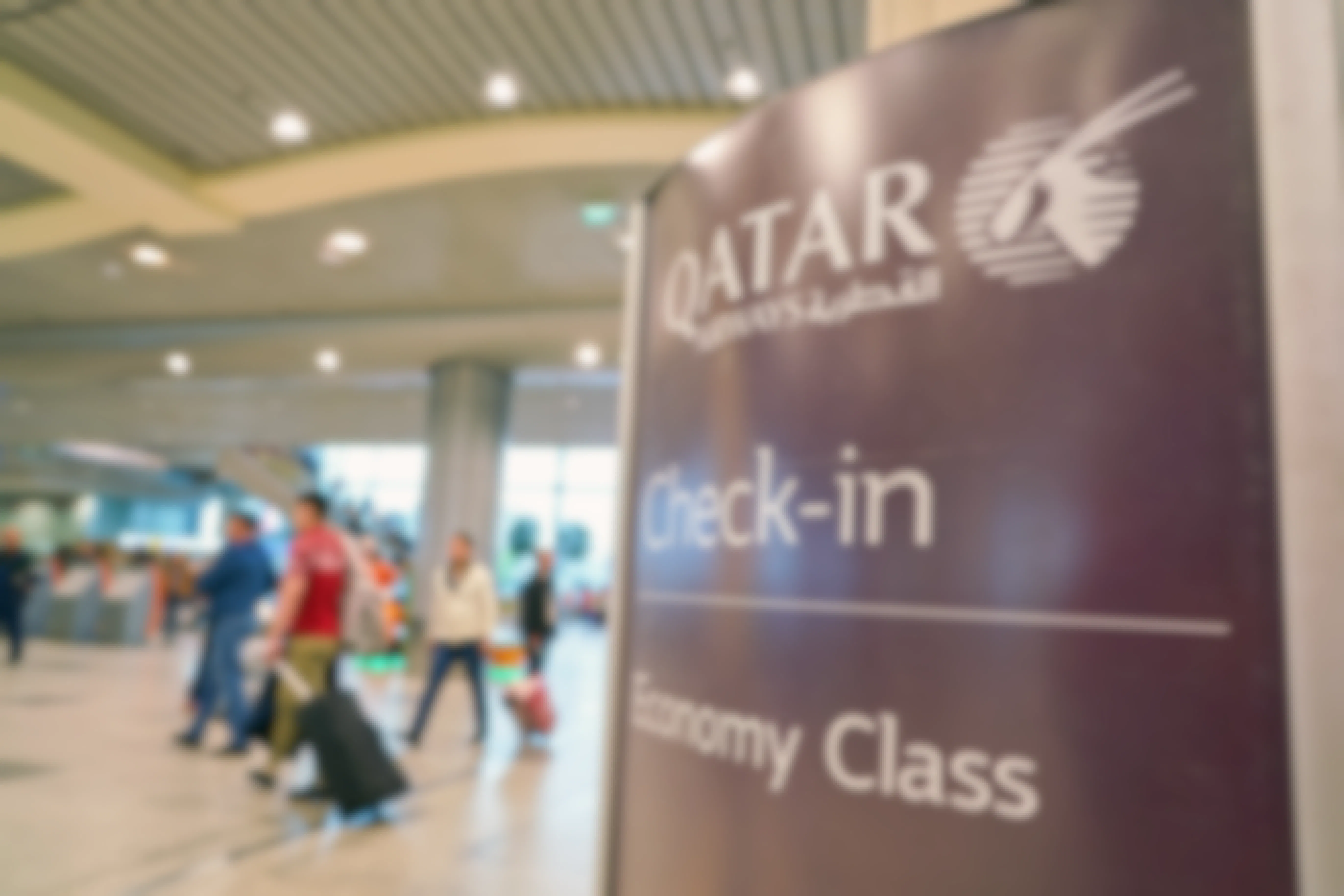 Qatar Airways Check-In sign for Economy Class passengers in the airport.