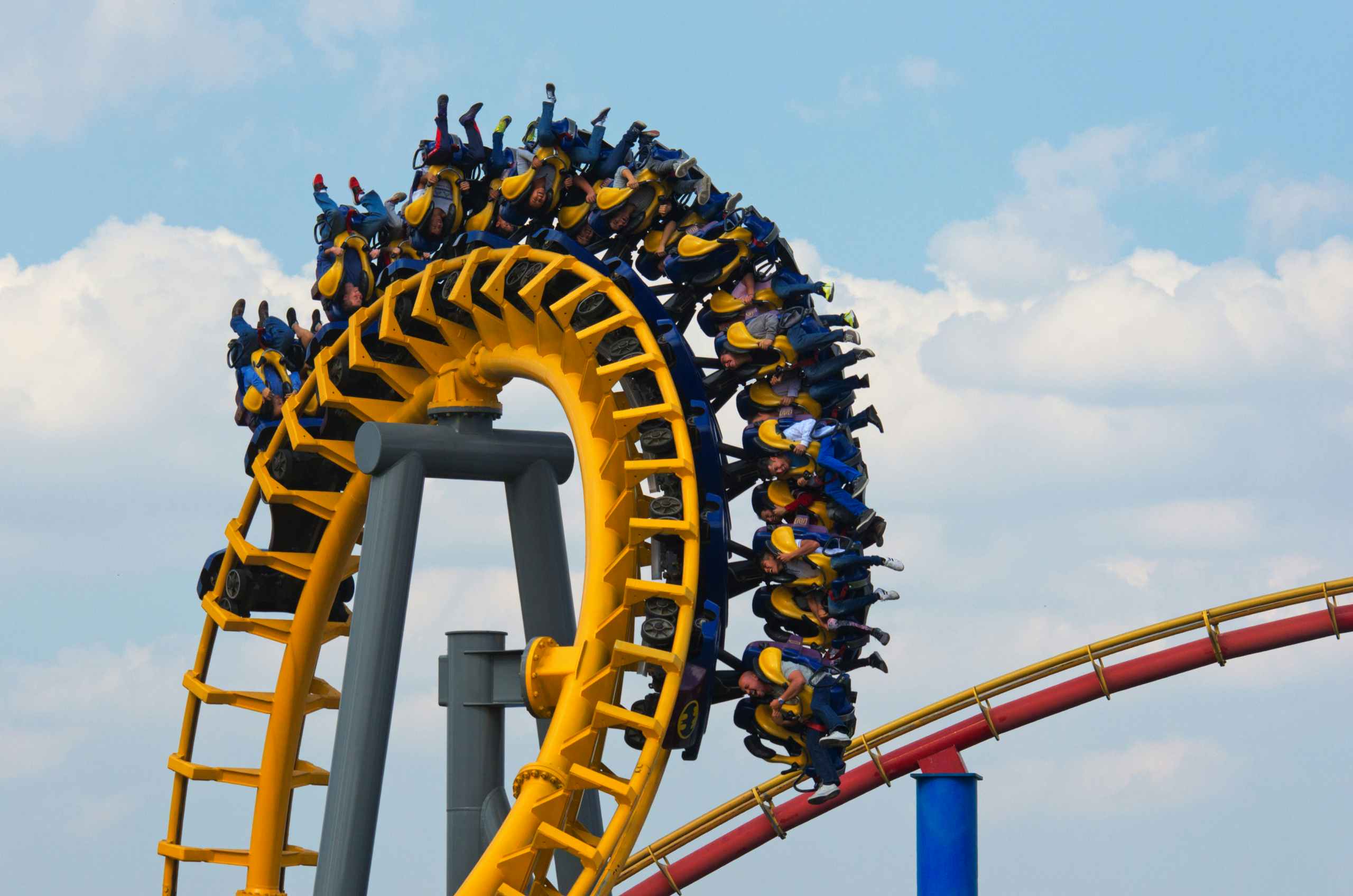 amusement park visitors on roller coaster ride