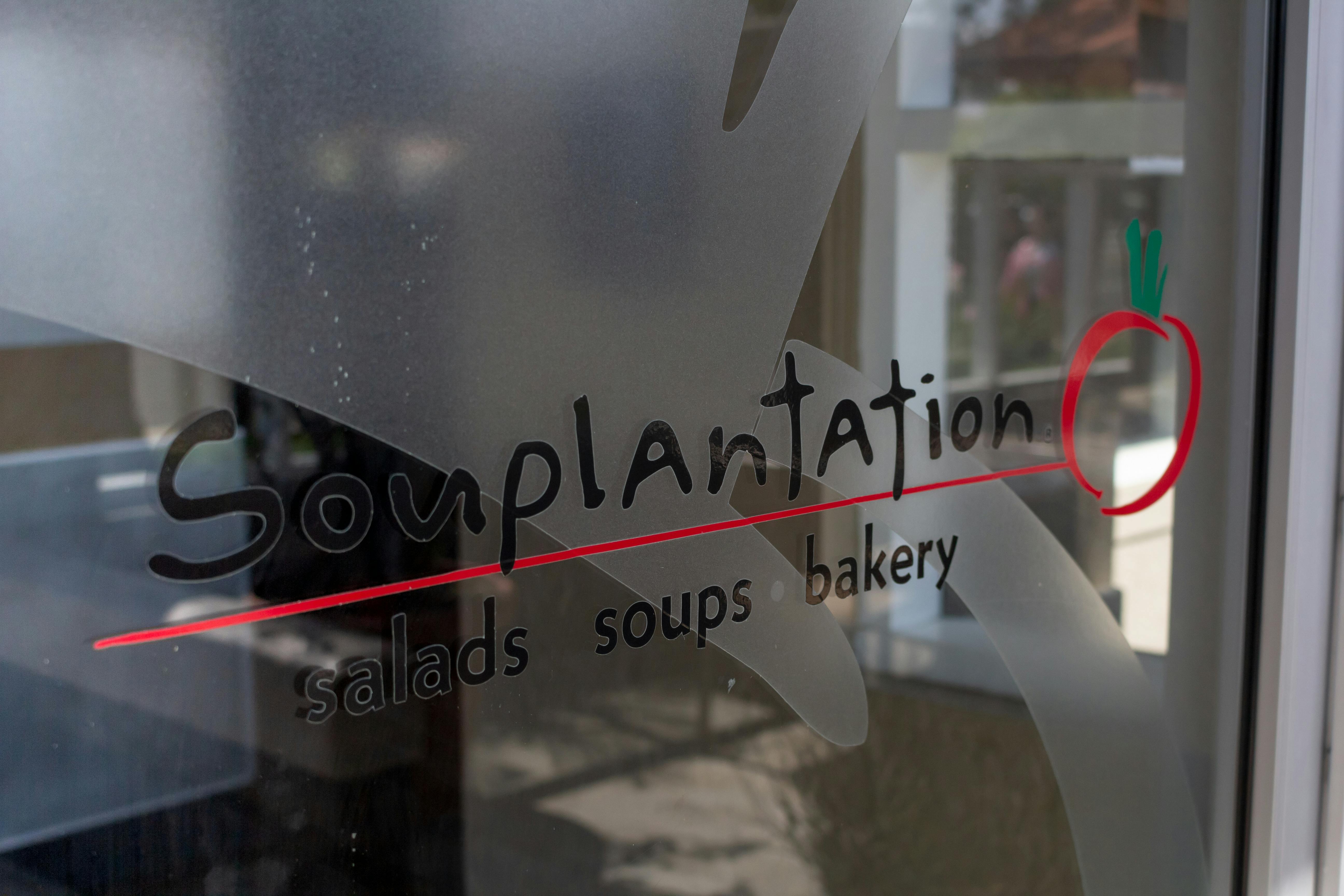 Souplantation branding on a glass door