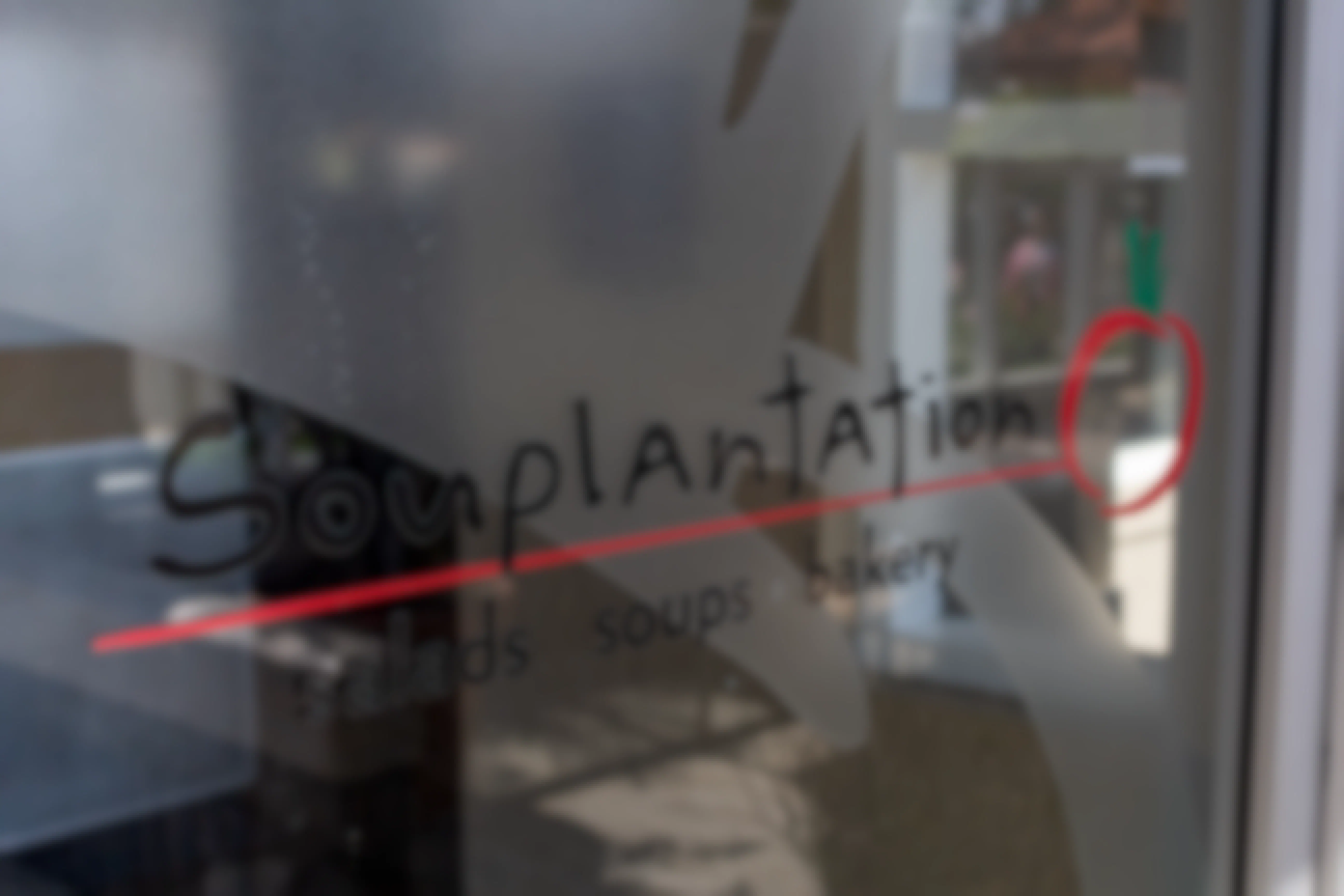 Souplantation branding on a glass door