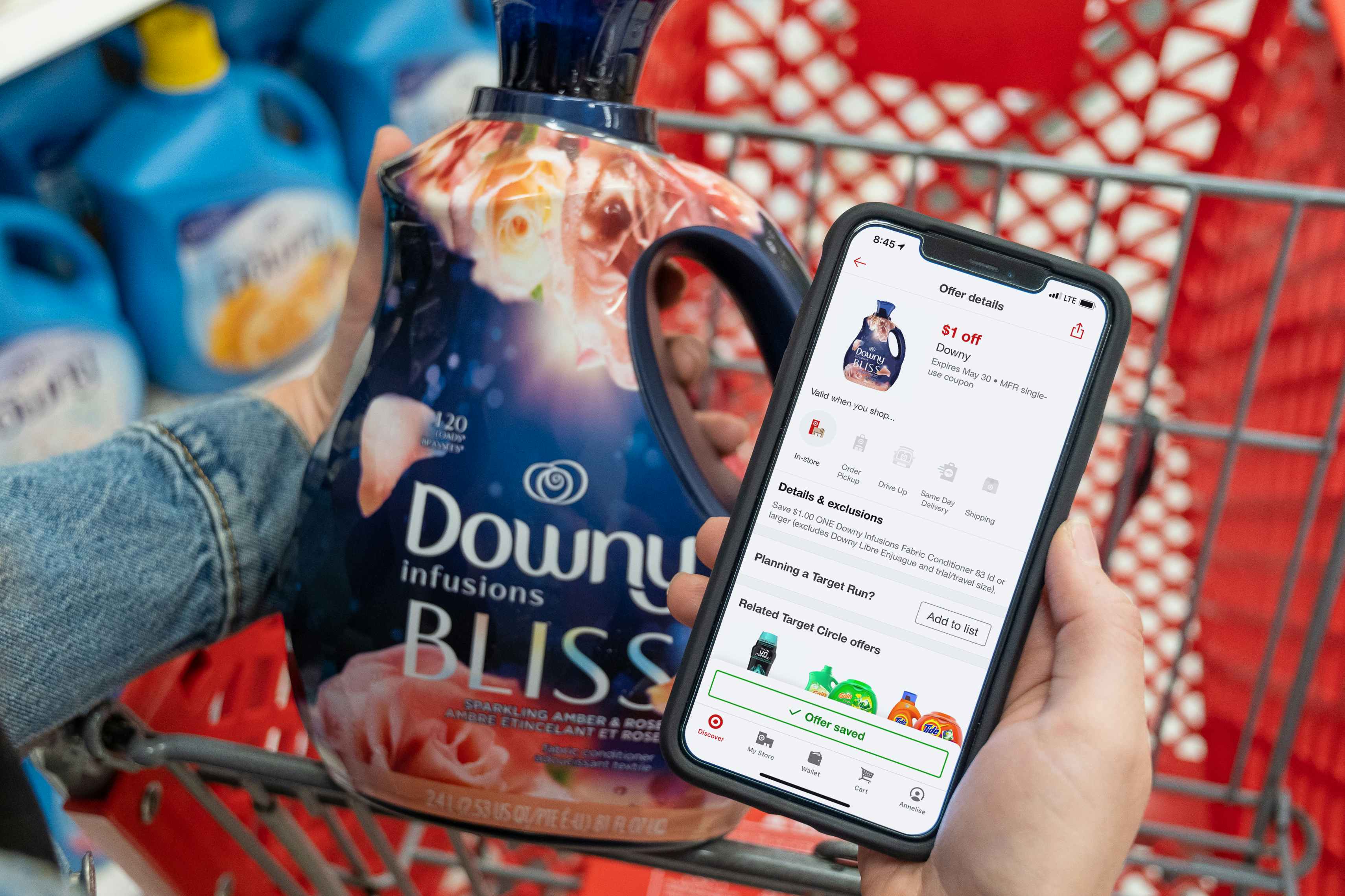 A bottle of Downy bliss fabric softener next to a manufactures coupon on the displayed on a the Target circle app..