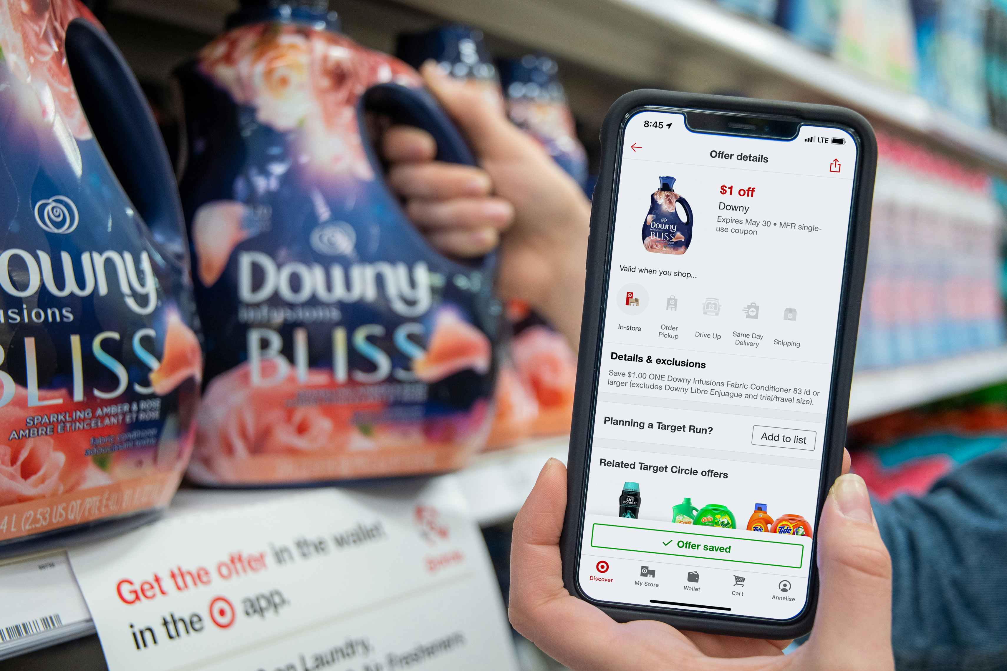 A bottle of Downy bliss fabric softener next to a manufactures coupon on the displayed on a the Target circle app..