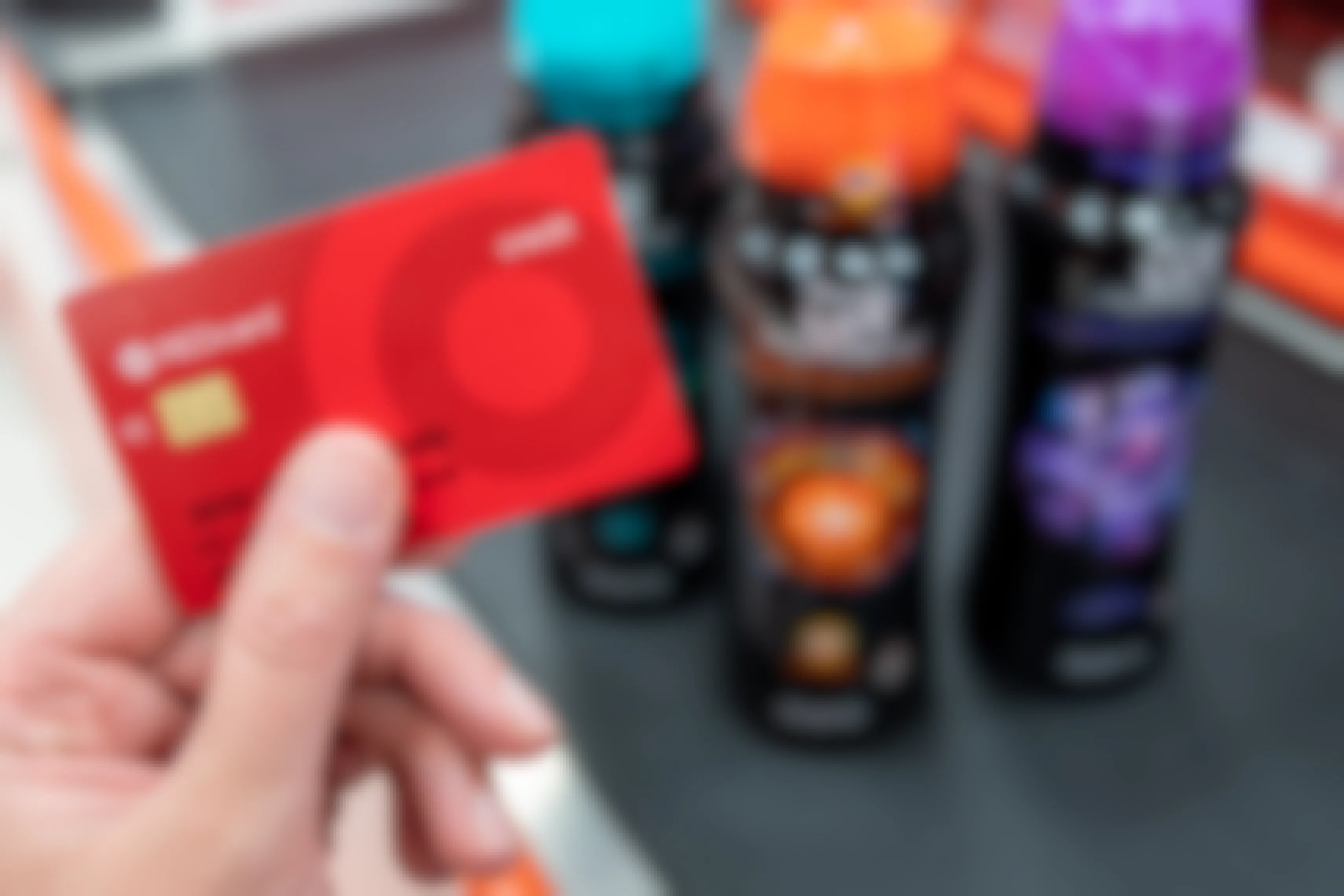 A Target red card held in front of Downy Unstopables bottles at a checkout register.
