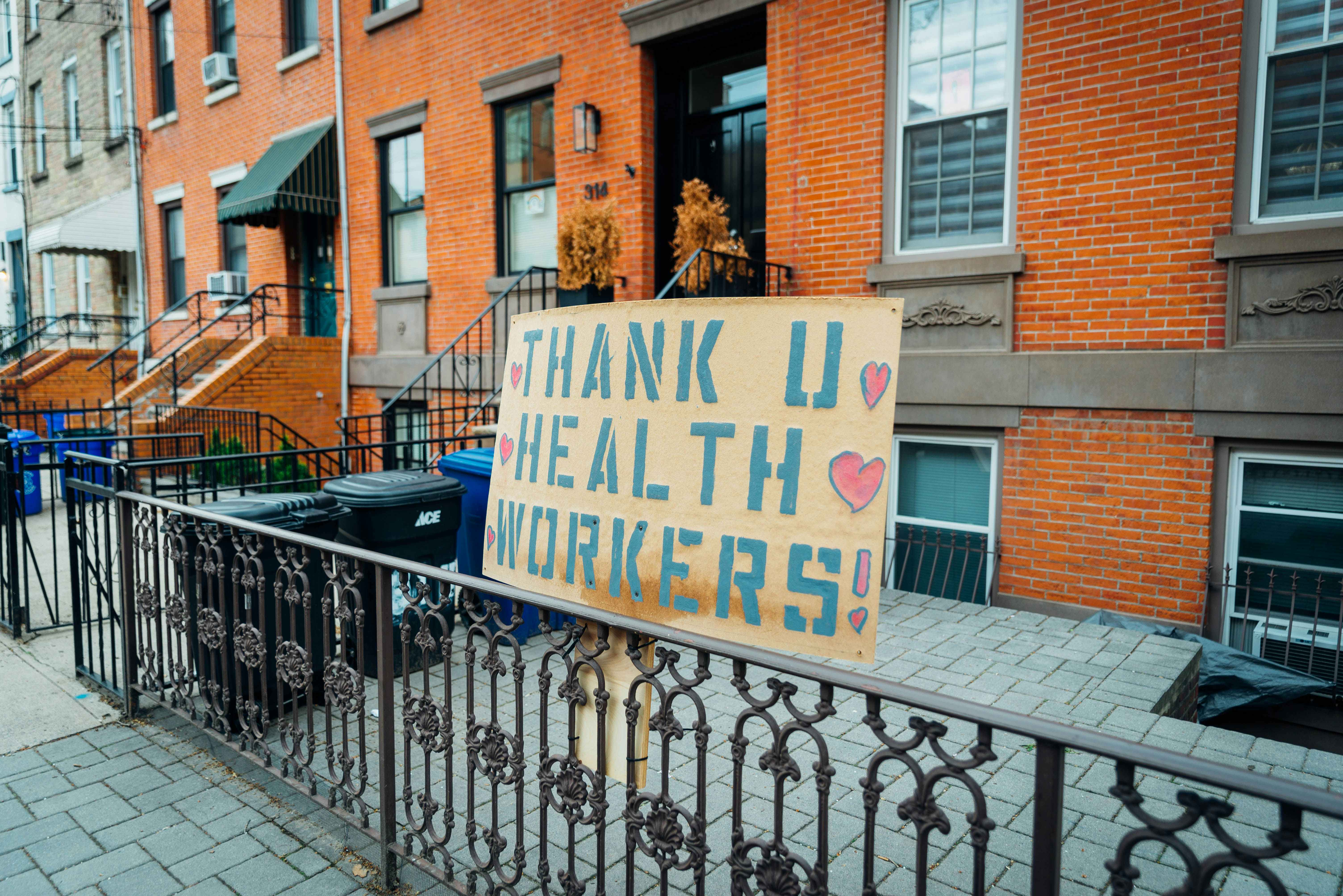 A "Thank U Health Workers" sign hung outside a city apartment building.