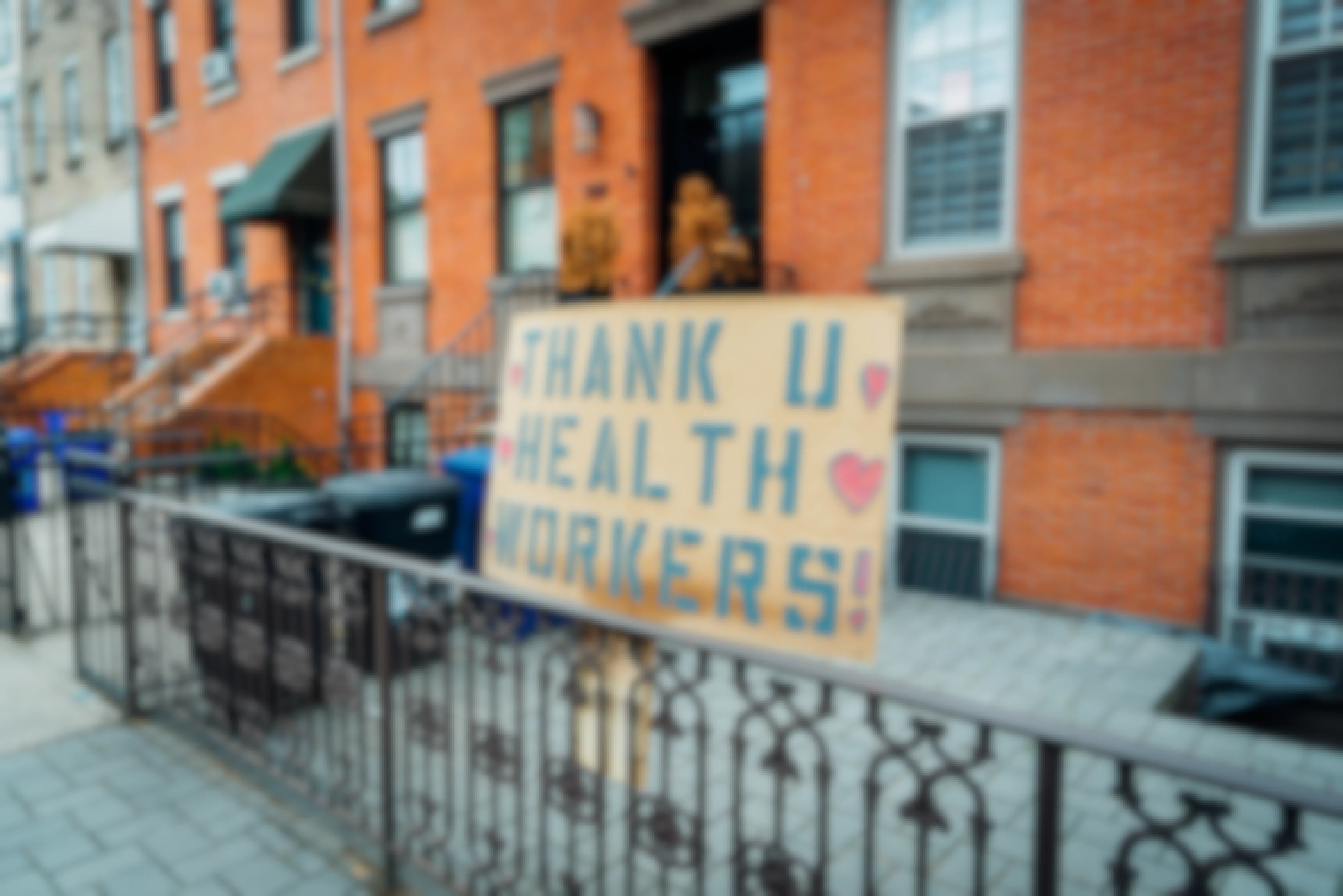 A "Thank U Health Workers" sign hung outside a city apartment building.
