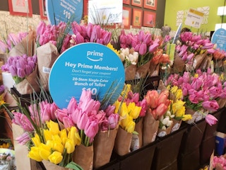 Bunches of Tulips with a Prime members sign indicating 20 stems for $10.