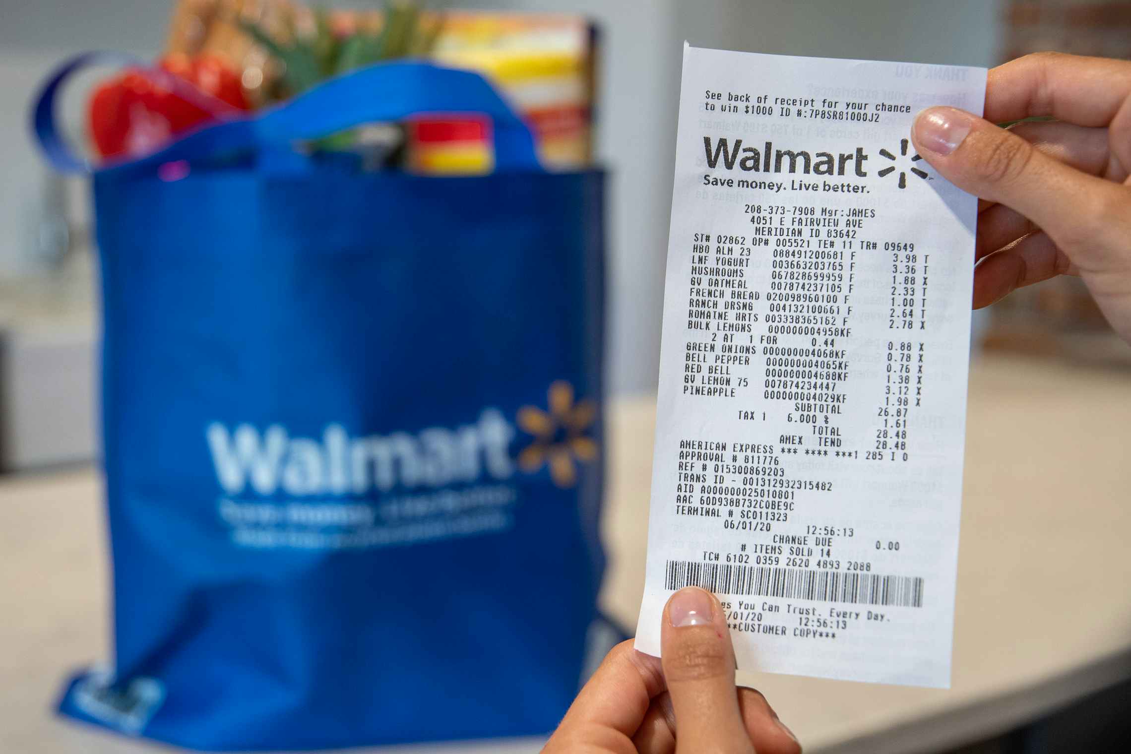 A walmart grocery receipt in front of groceries on a counter.