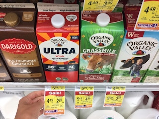 Milk and dairy products on the shelf at Albertsons with sale tags.