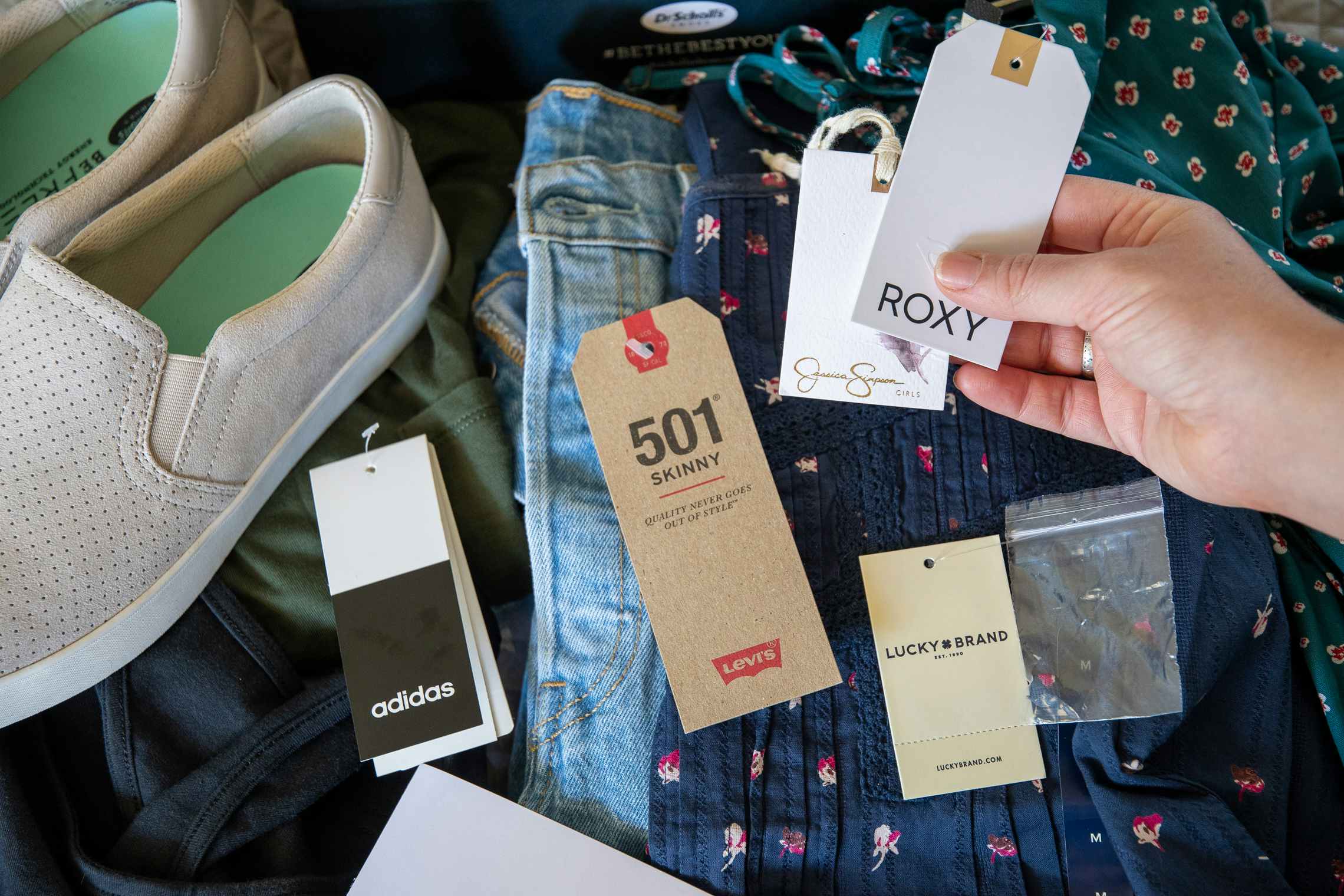 Name brand clothing tags attached to items of clothing