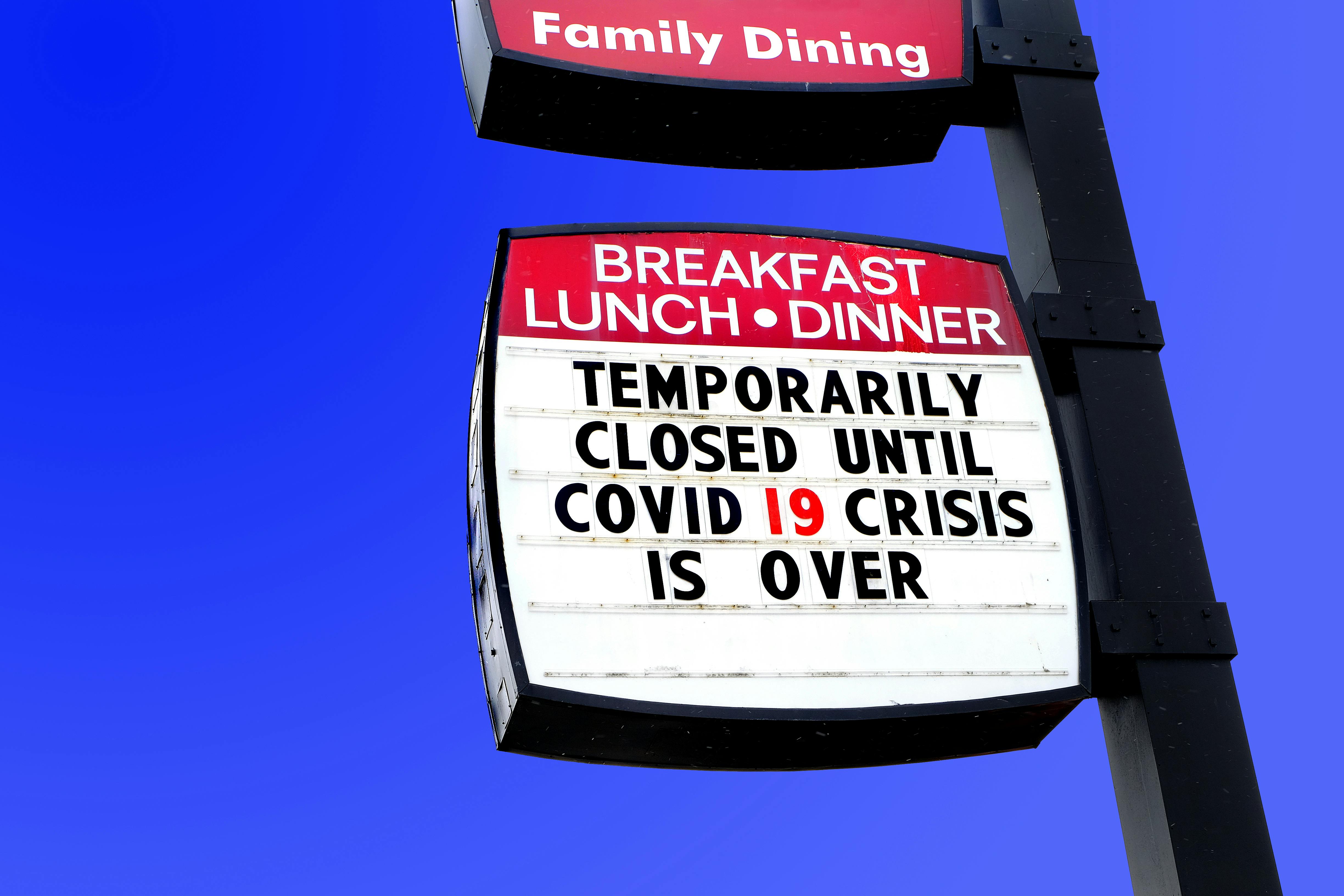 Restaurant sign announcing closure until COVID-19 passes over.