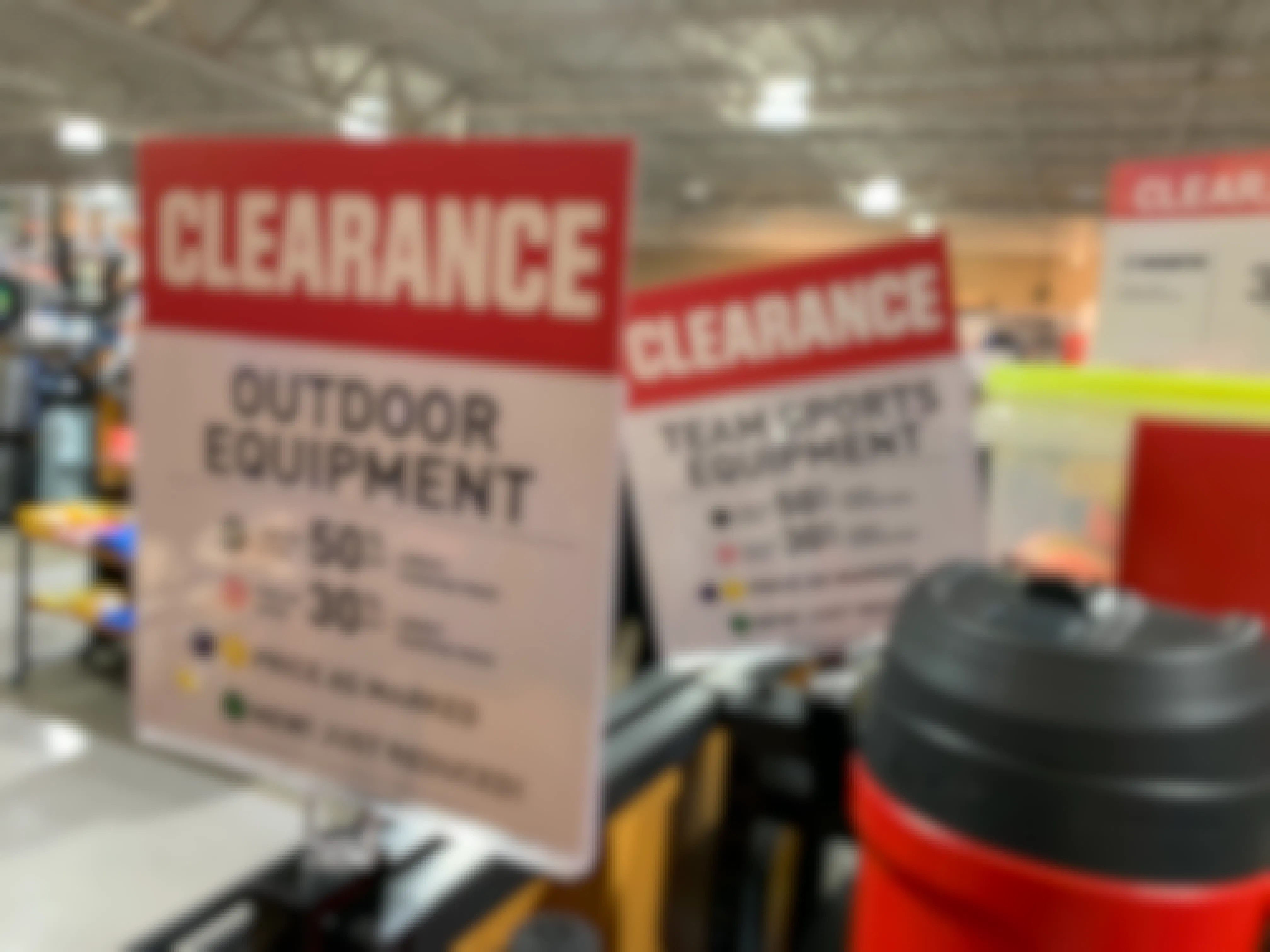 Dick's Sporting Goods clearance signs in-store for shoppers.
