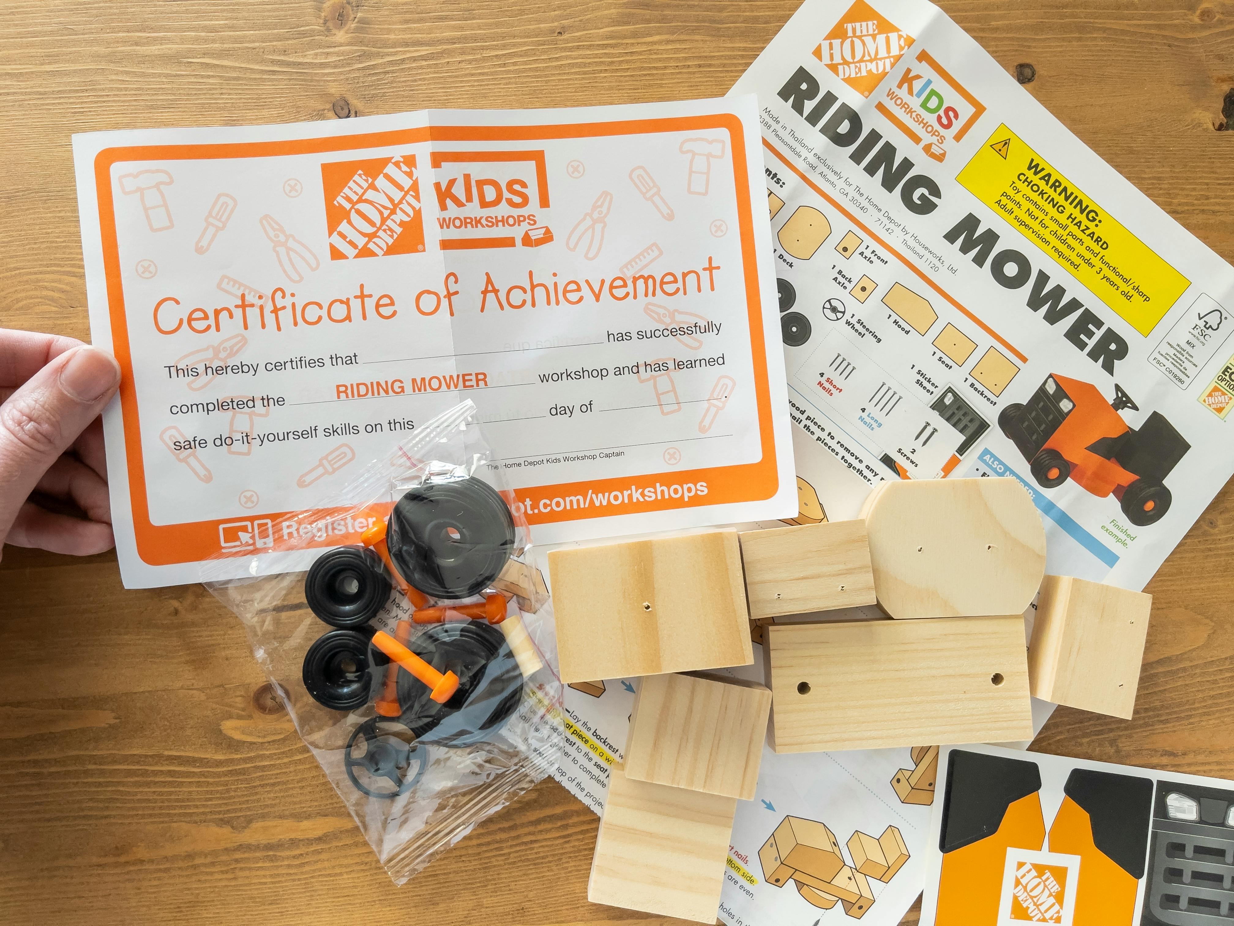 A Home Depot Kids Workshops Riding Mower kit open on a table.