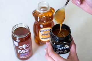 Three jars of different kinds of honey, showing the varying colors of the honey.