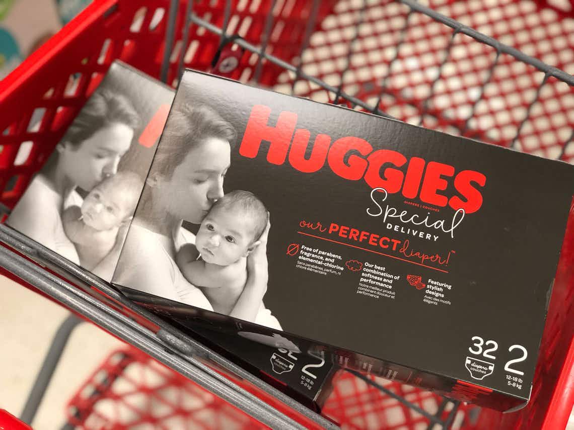 Two boxes of Huggies special delivery in the basket of a Target shopping cart.