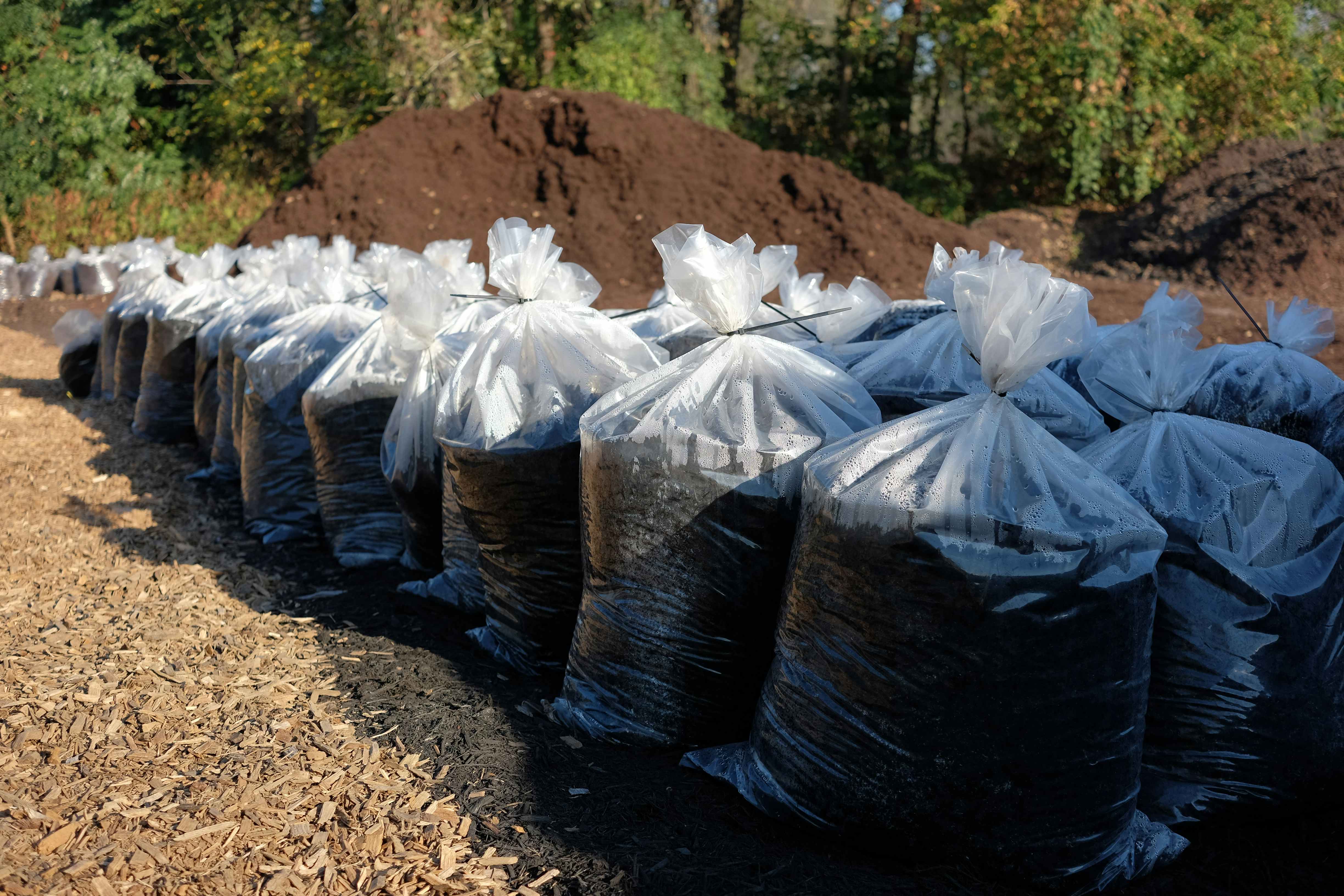 Bags of mulch in an outdoor garden center