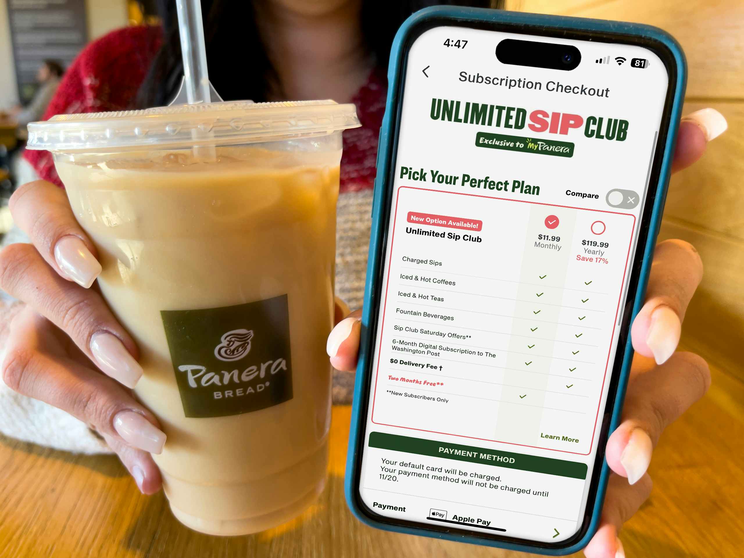 A woman holding an iced coffee in a panera cup next to a cell phone displaying a deal for the unlimited sip club on the panera app.
