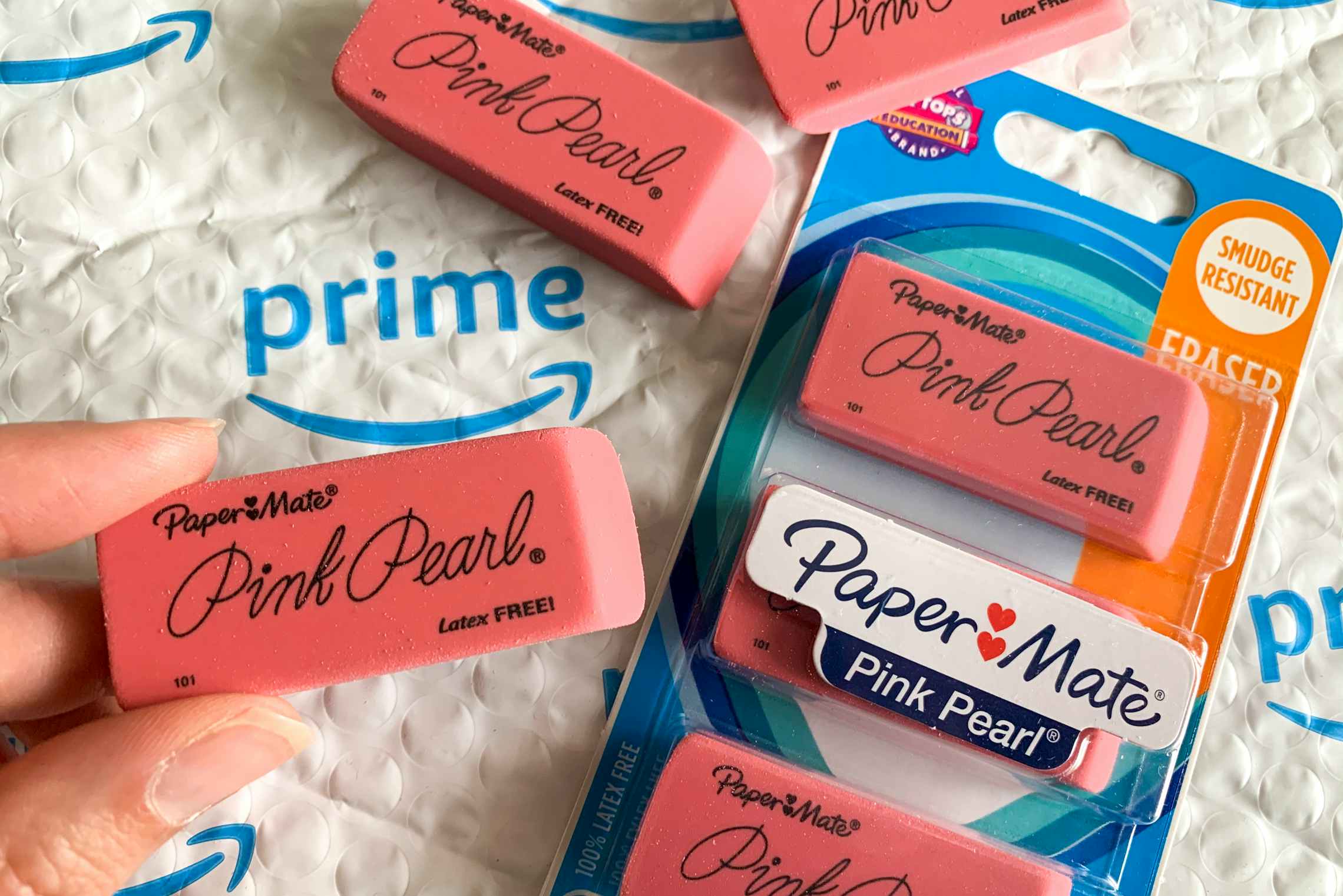 Paper Mate Pink Pearl erasers on top of an Amazon prime envelope.