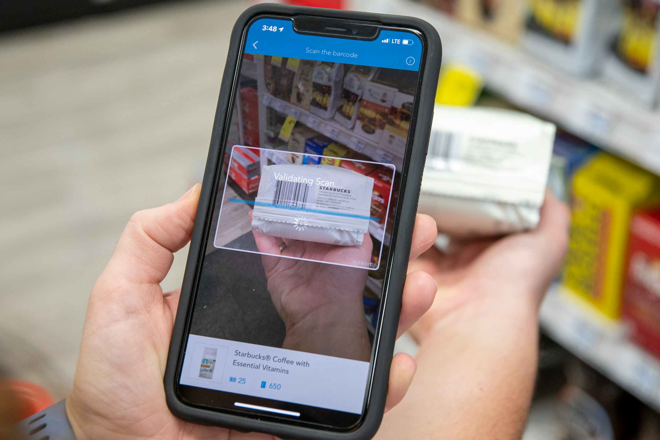 A person scanning a bag of coffee with the shopkick app.