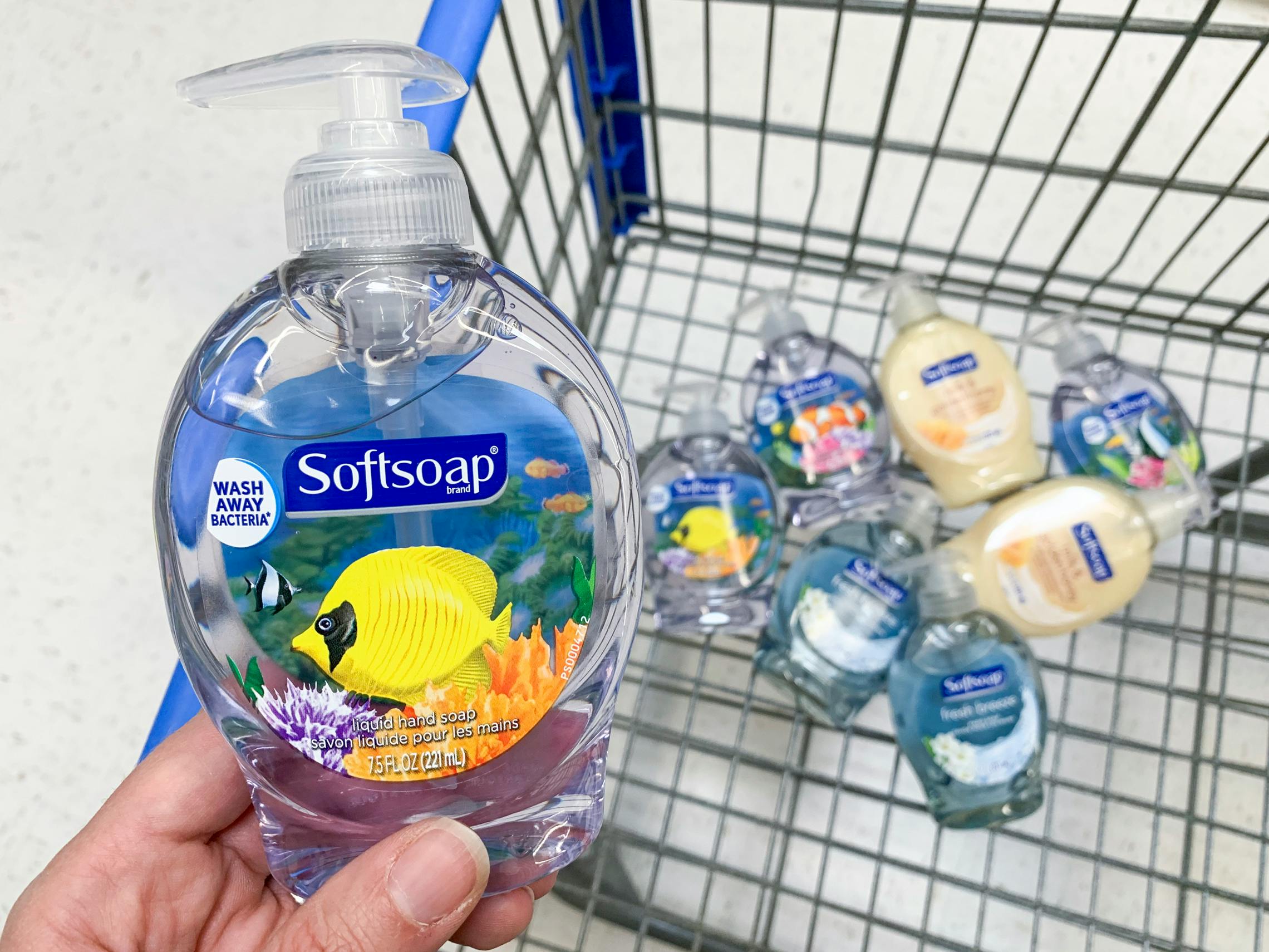 Hand soap held in over a shopping cart filled with the same products.