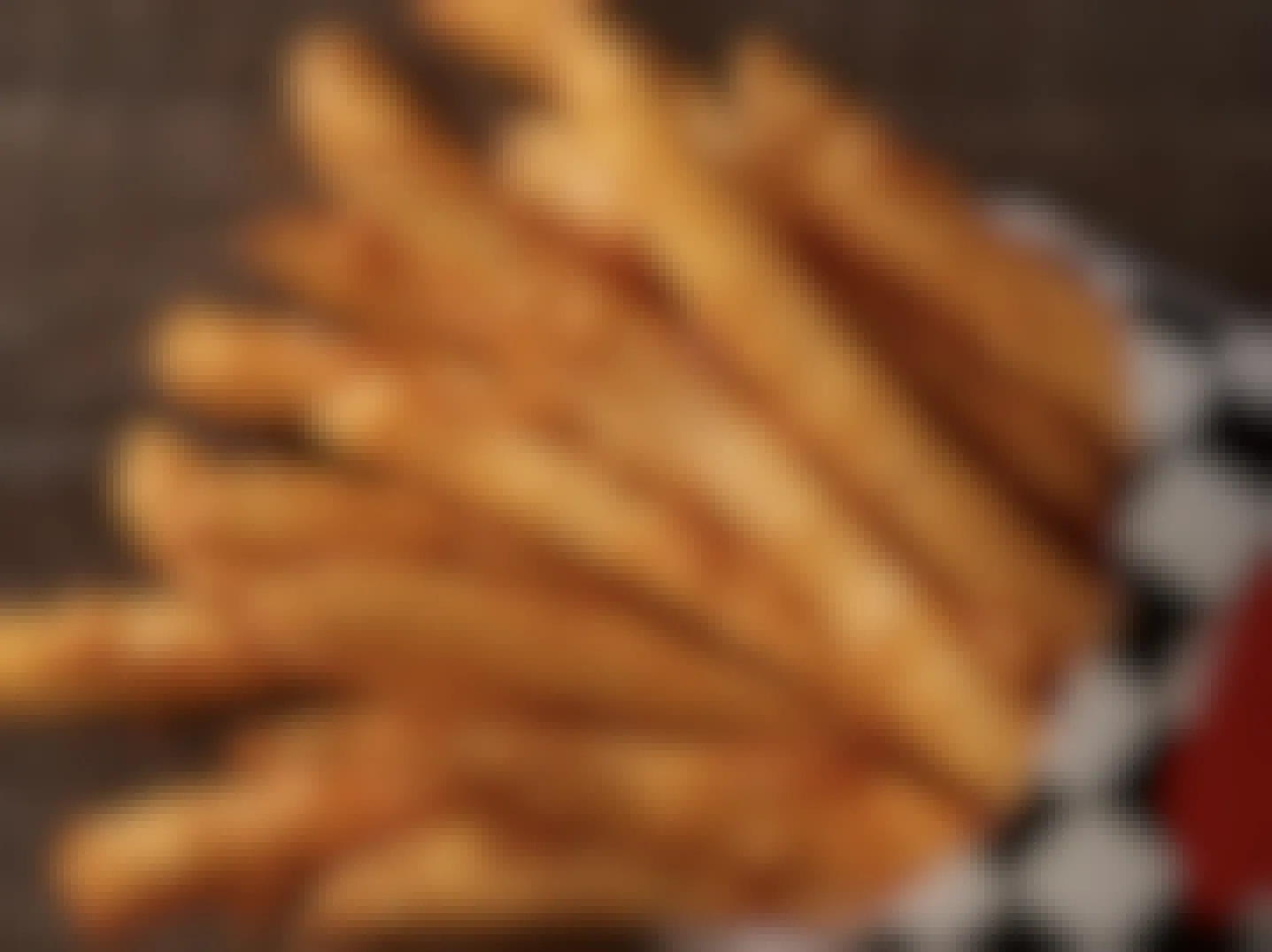 A close up of a large fry from Checkers on a table.