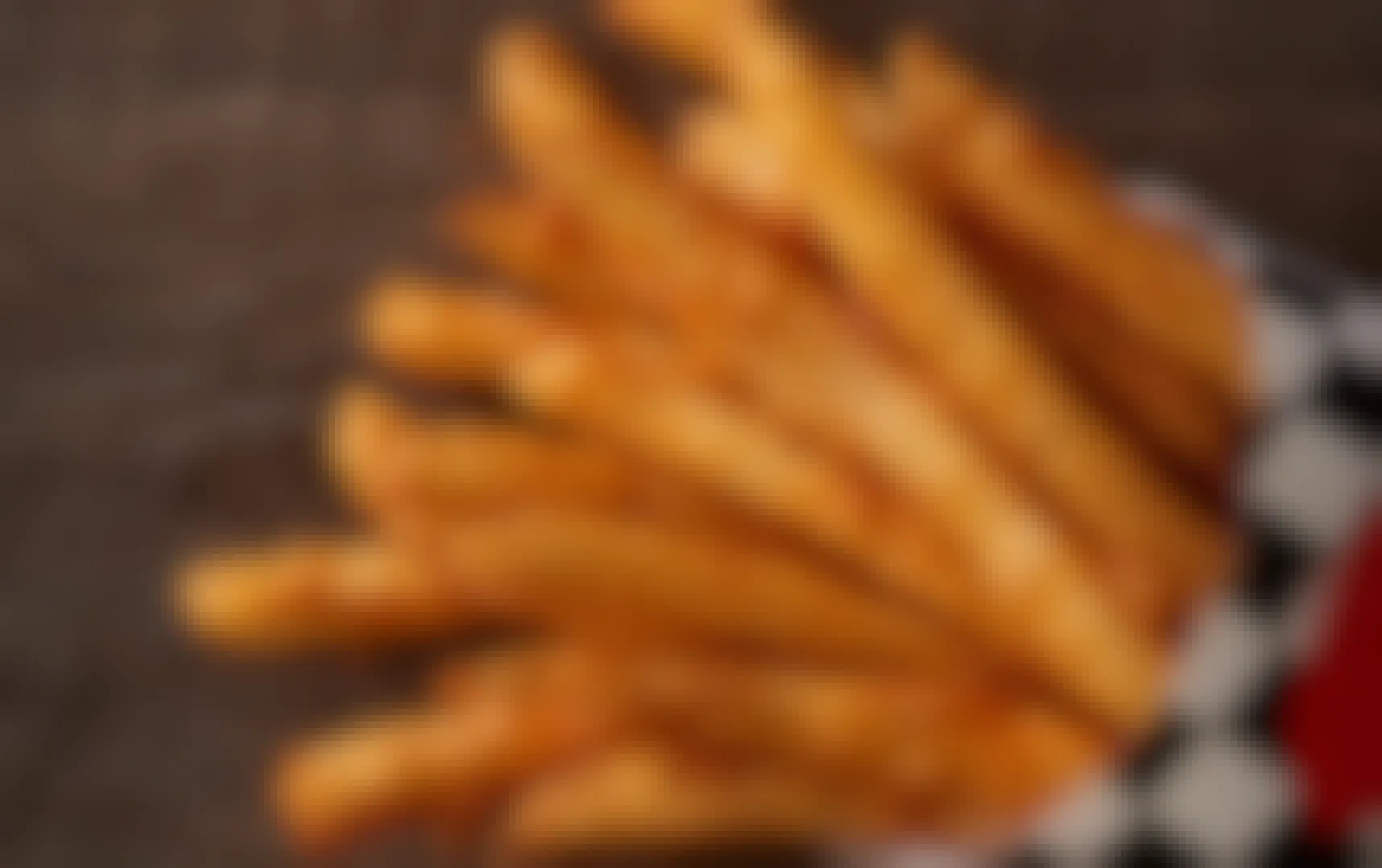 A close up of a large fry from Checkers on a table.