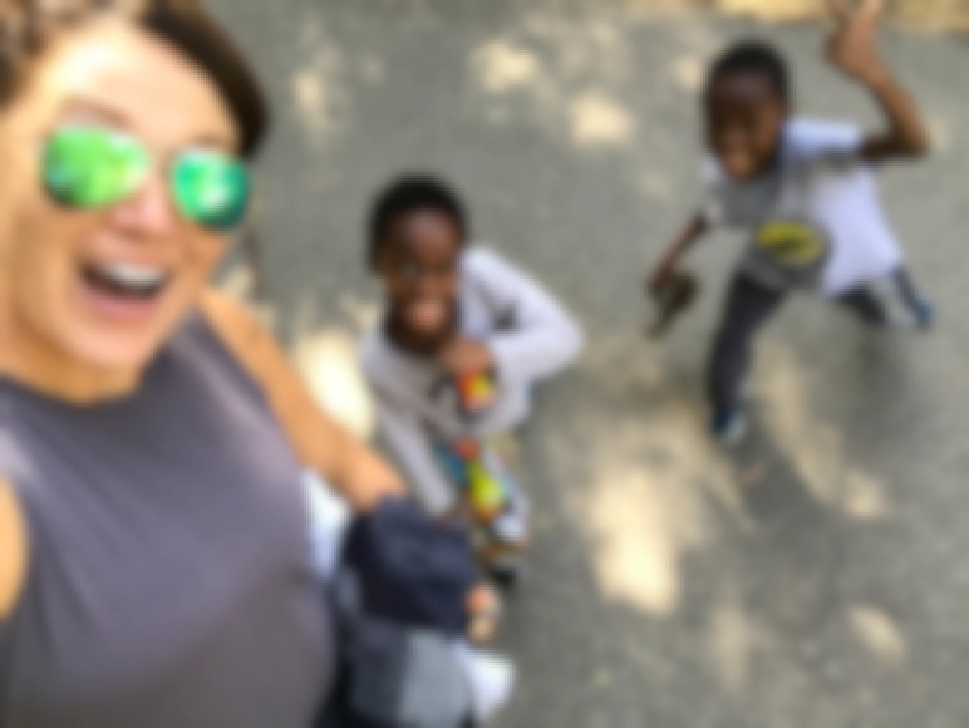 Two kids and their mom taking a selfie while on a walk.