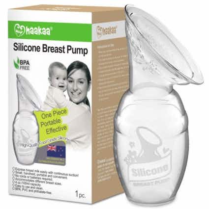 A Haakaa Silicone breast pump next to its box on a white background.