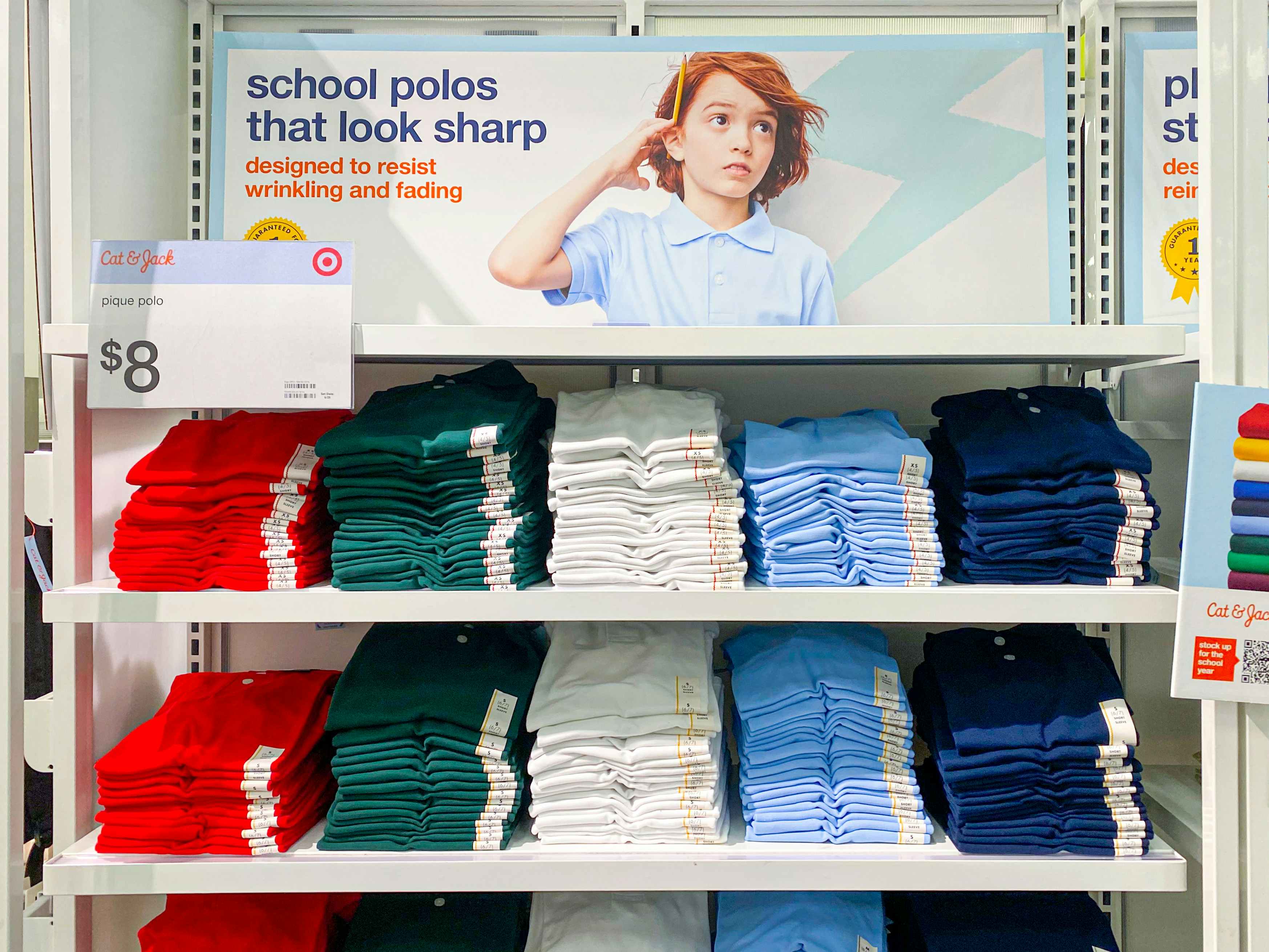 A shelf of Cat & Jack kids school uniform polo shirts at Target.