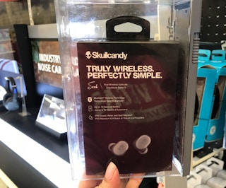 someone holding skullcandy headphone box
