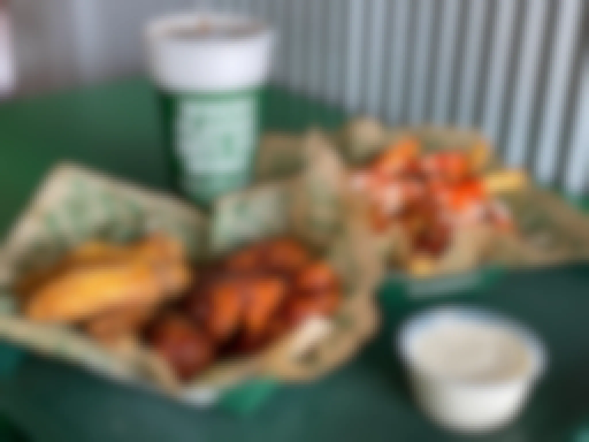 Wingstop wings, fries, and a drink sitting together on a table at Wingstop.