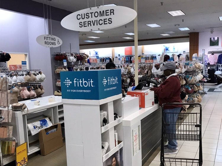 A woman standing at the customer services counter.