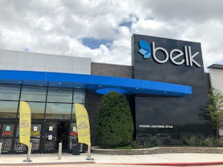 A Belk storefront under a cloudy sky.