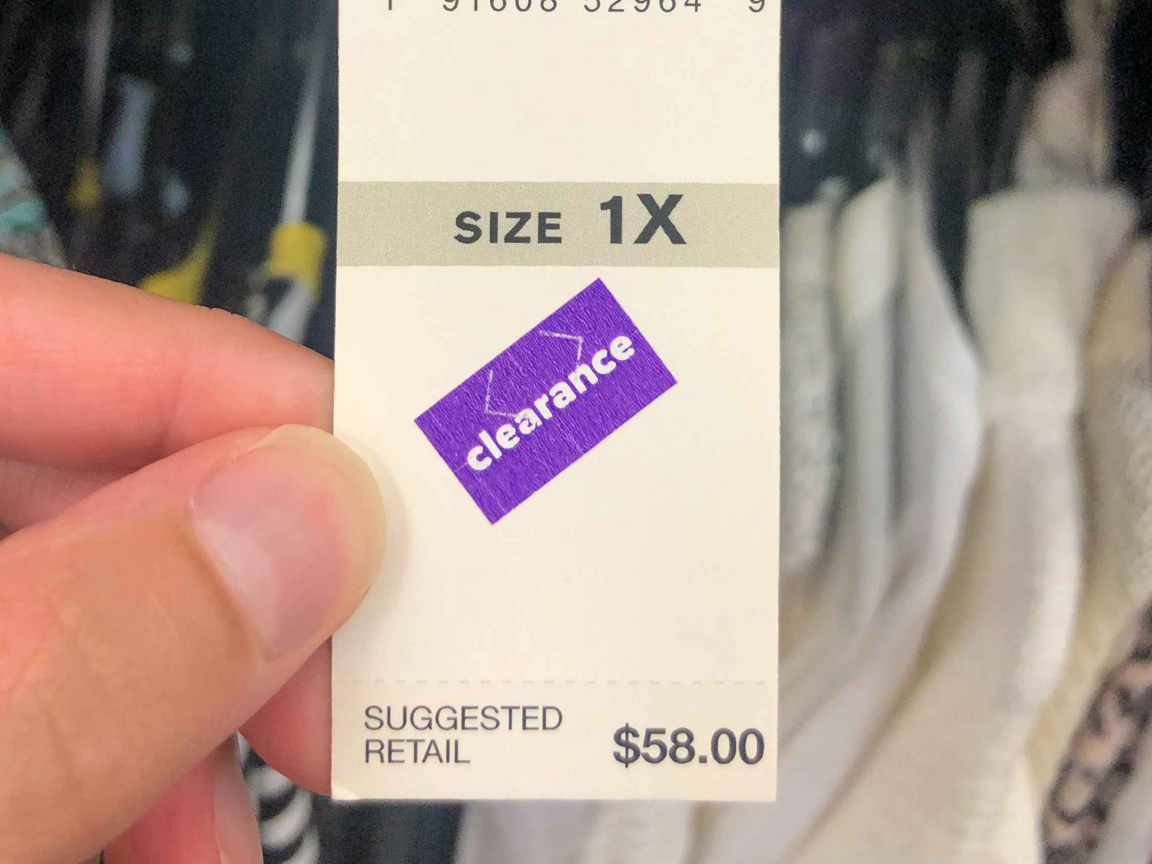 A purple clearance sticker on a Belk item price tag.